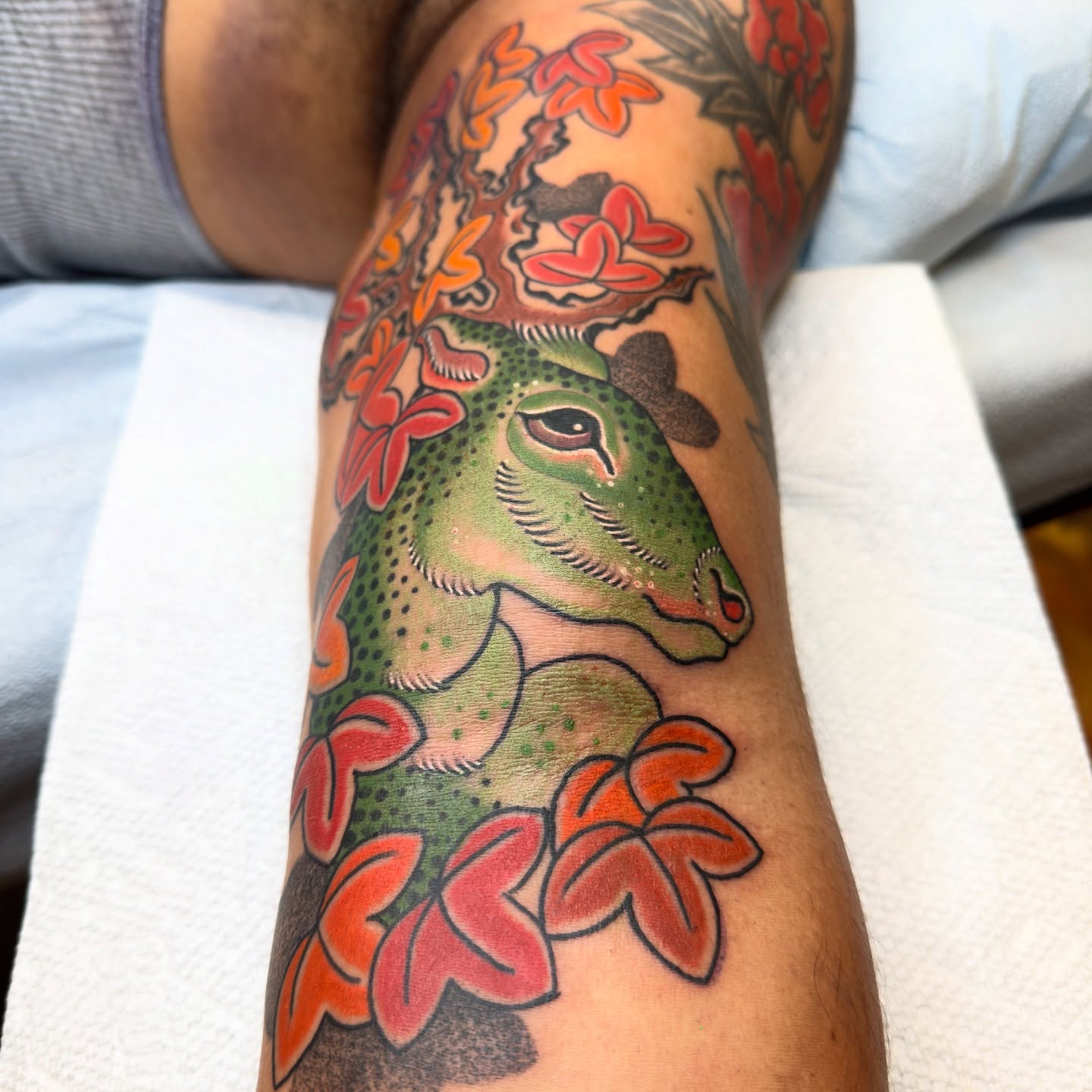 Deer with flowers American traditional tattoo on the forearm by Jhon