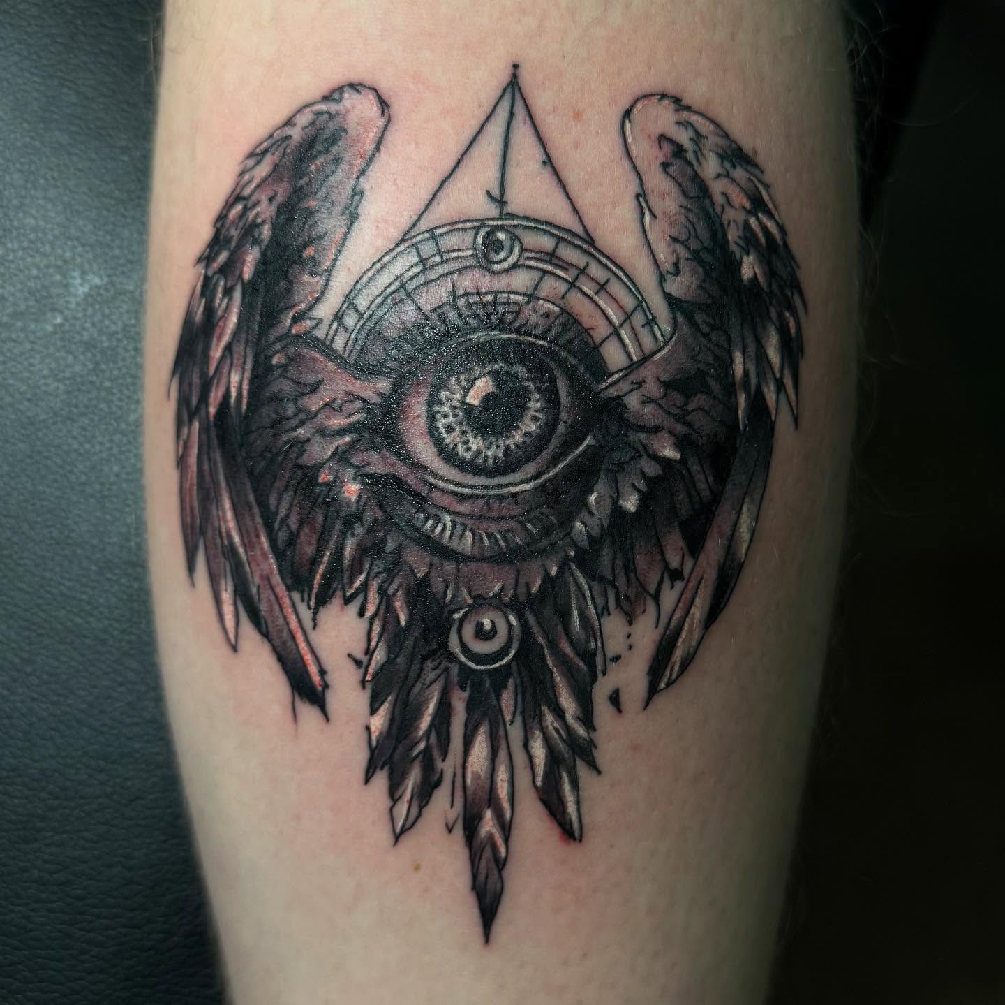 Eye with wings geometric tattoo on the forearm by Therapy ink