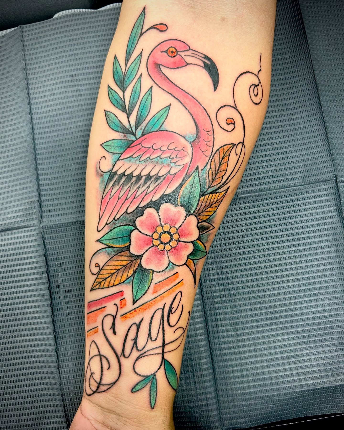 Flamingo and flower American traditional tattoo on the forearm by Patricia Cunningham