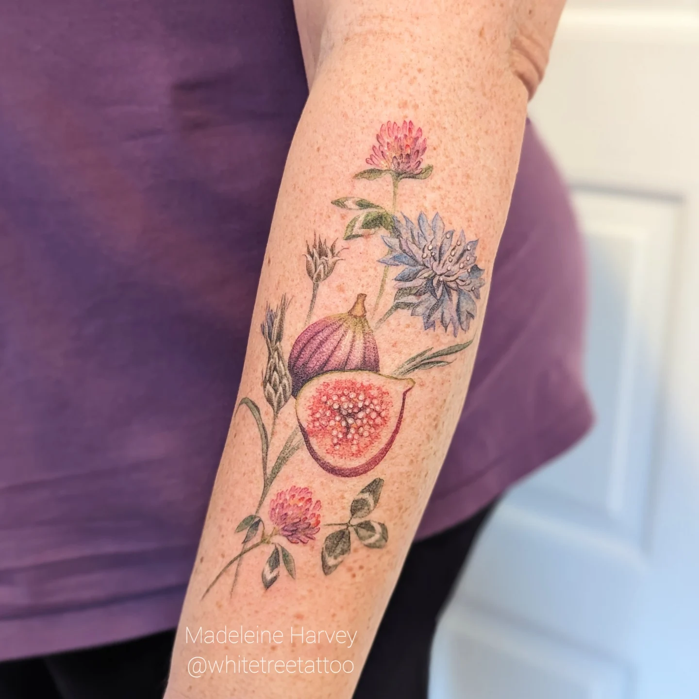 Figs and flowers realism tattoo on the forearm by Maddie