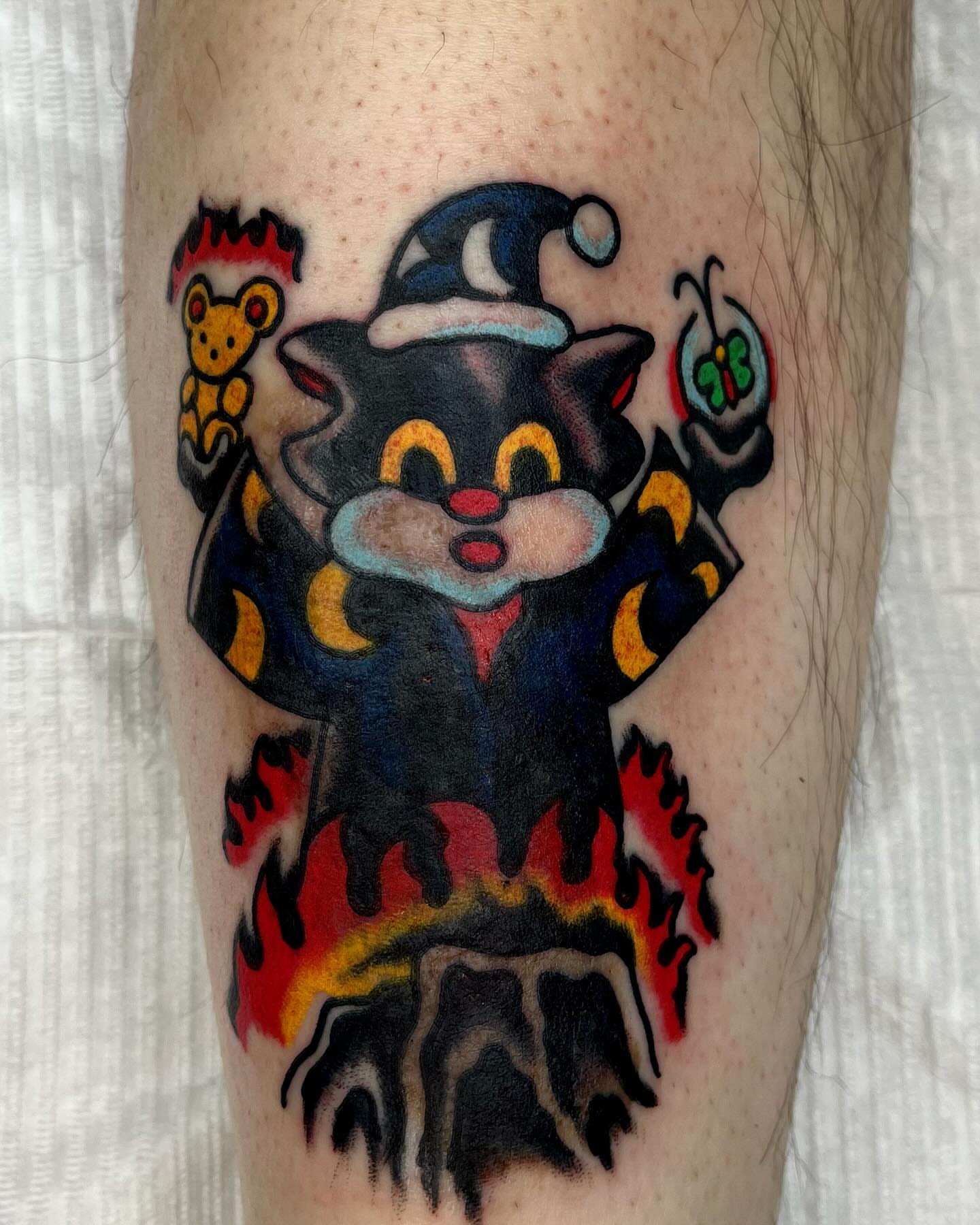 Cat American traditional tattoo on the forearm by Jimmy Ho