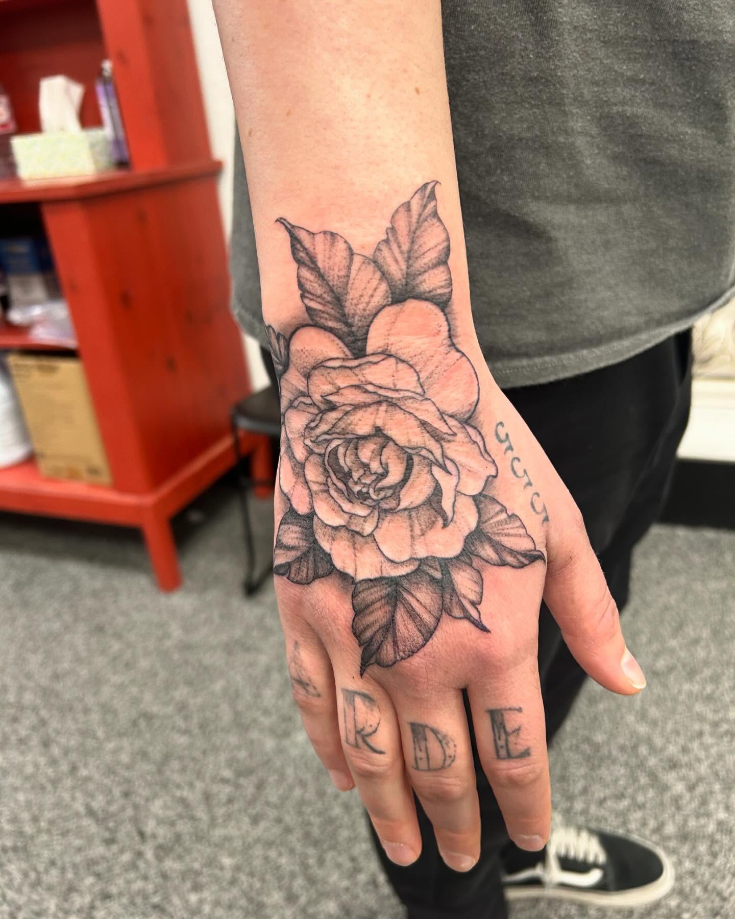 Rose black and grey tattoo on the hand by Jayda Shell