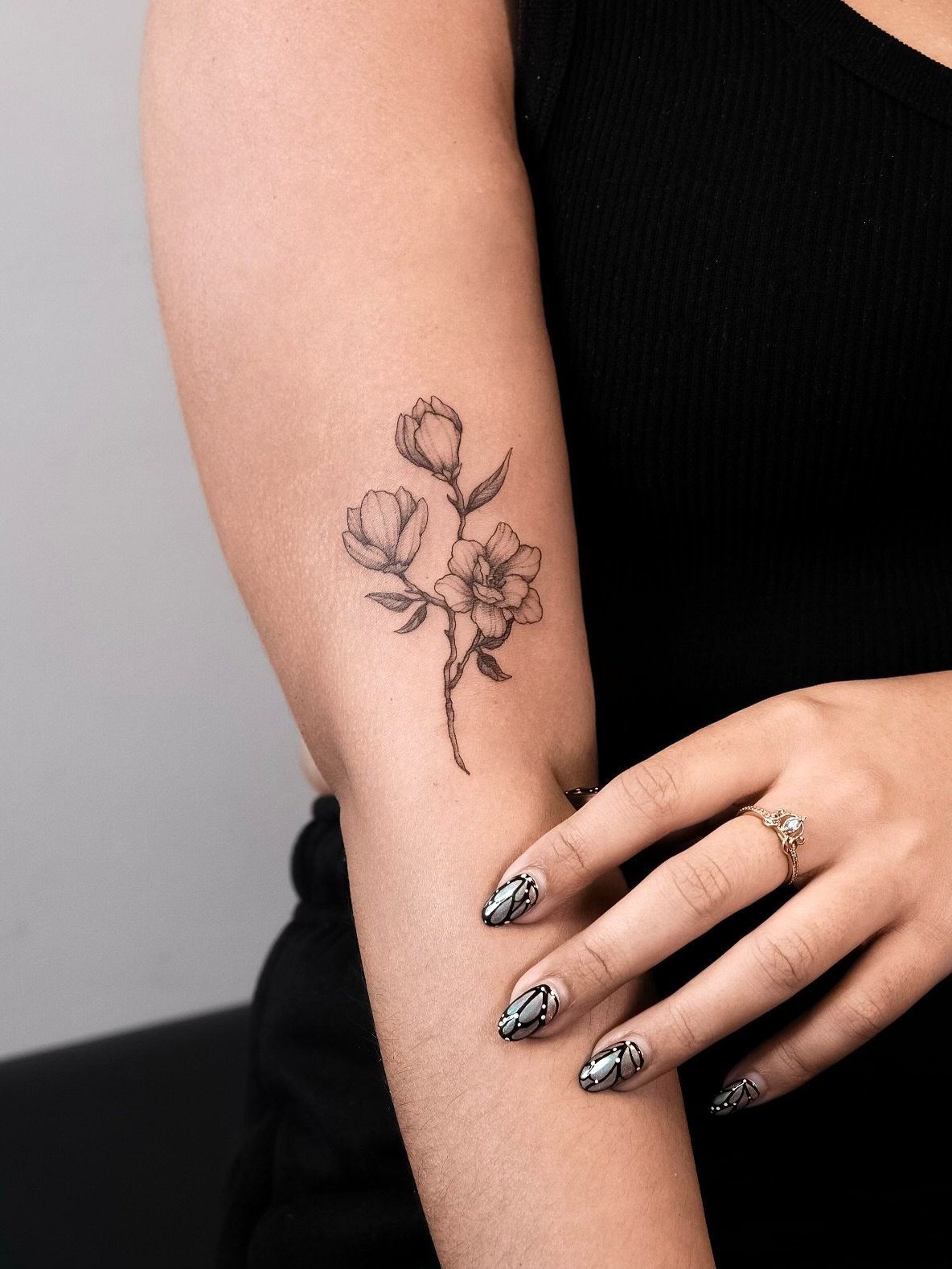Flower black and grey tattoo on the forearm by Your tattoo Artist, New York, New York