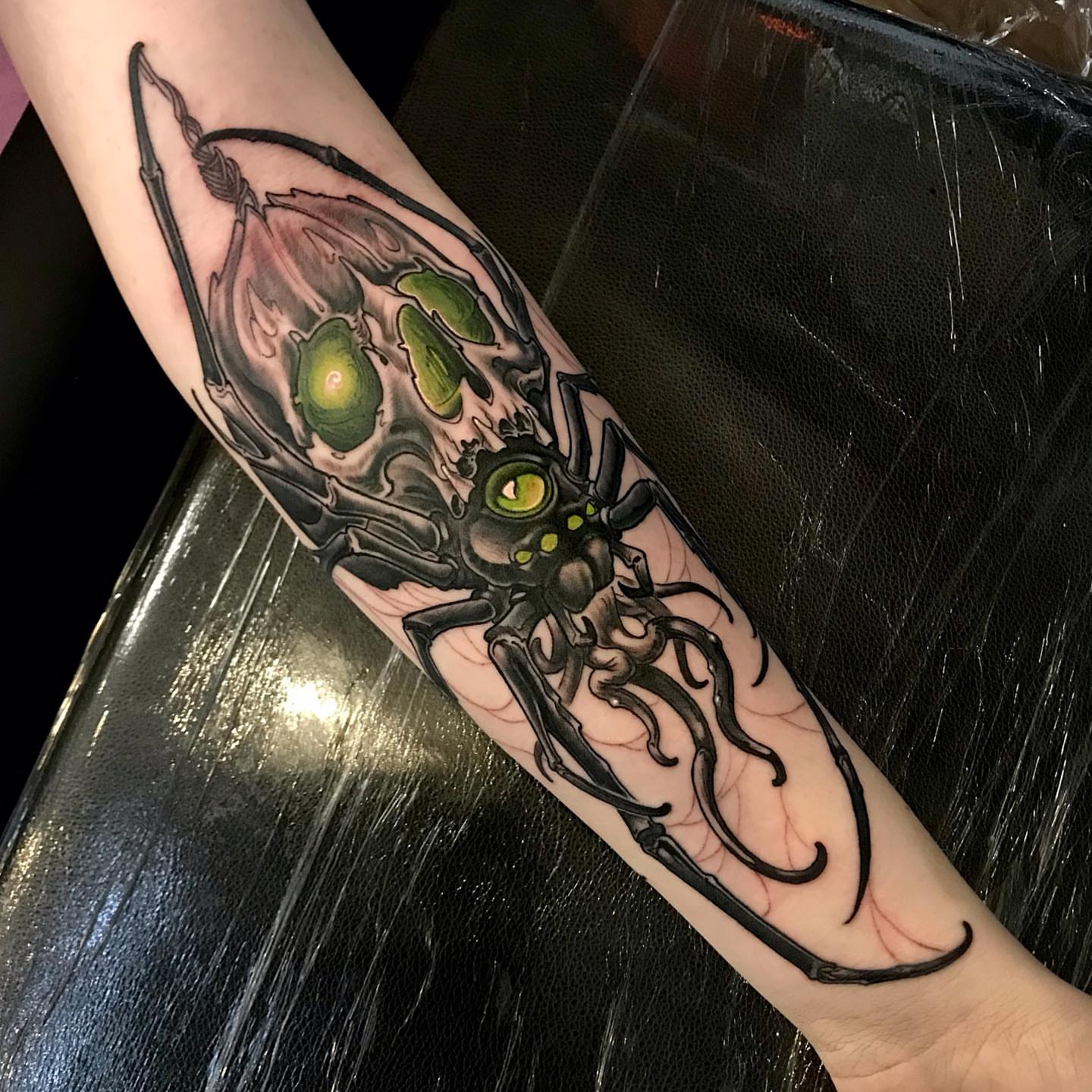 Cyborg insect dark realism tattoo on the forearm by Rick Rayne