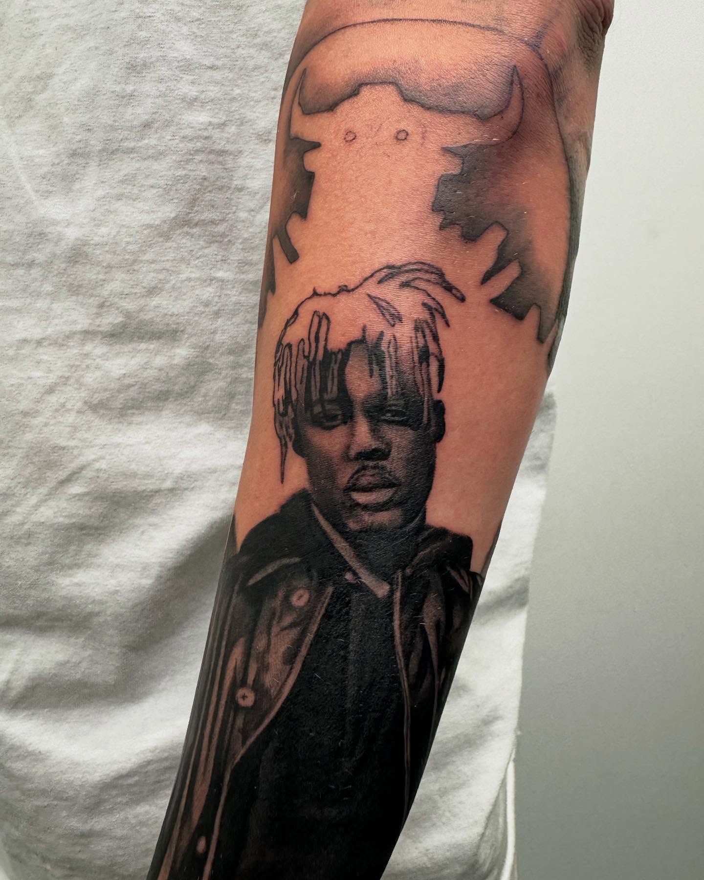 Portrait of a person black and grey tattoo on the forearm by Sam Oakes