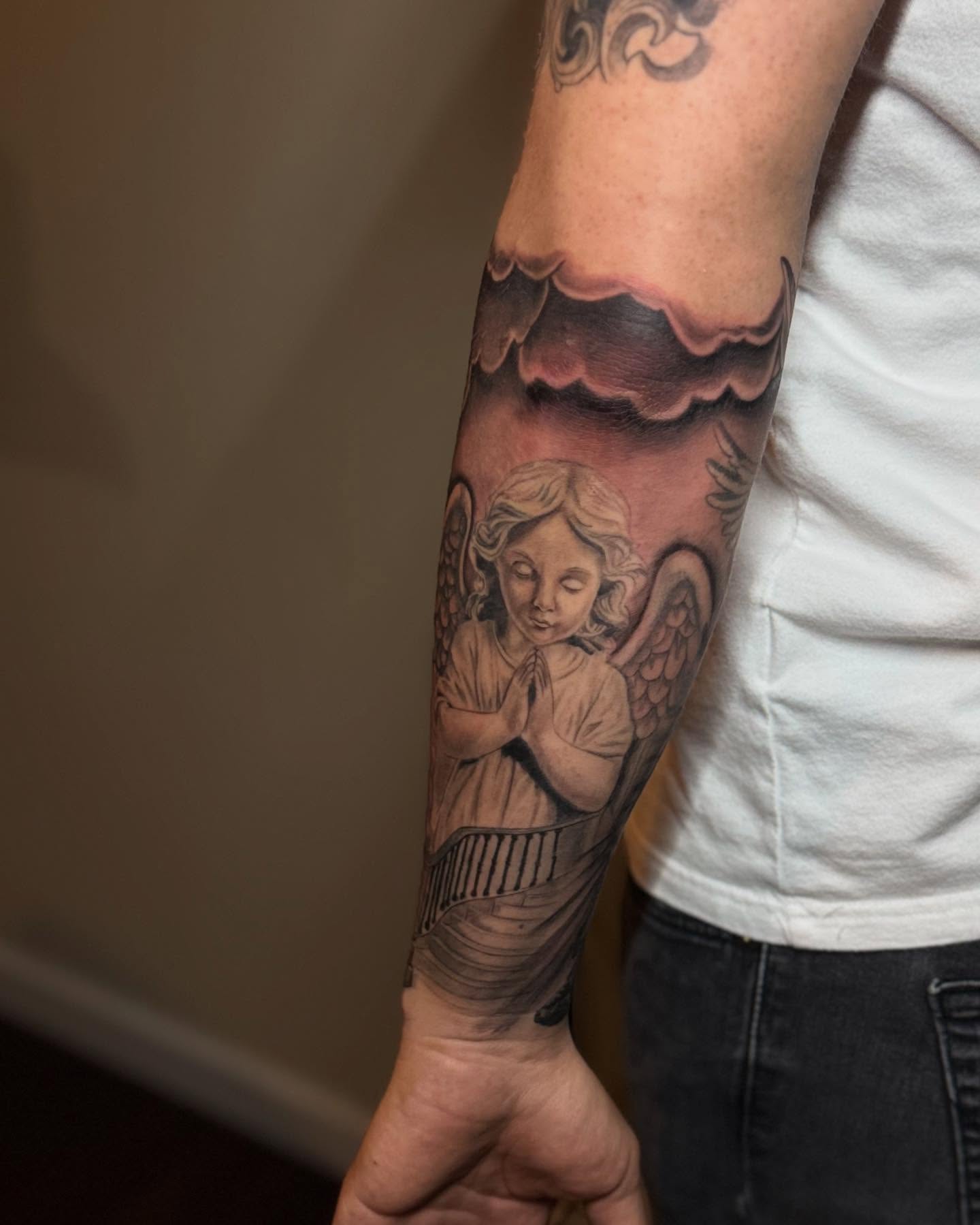 Angel praying realism tattoo on the forearm by Elian Sanchez Austin Tx. Tattoo Artist