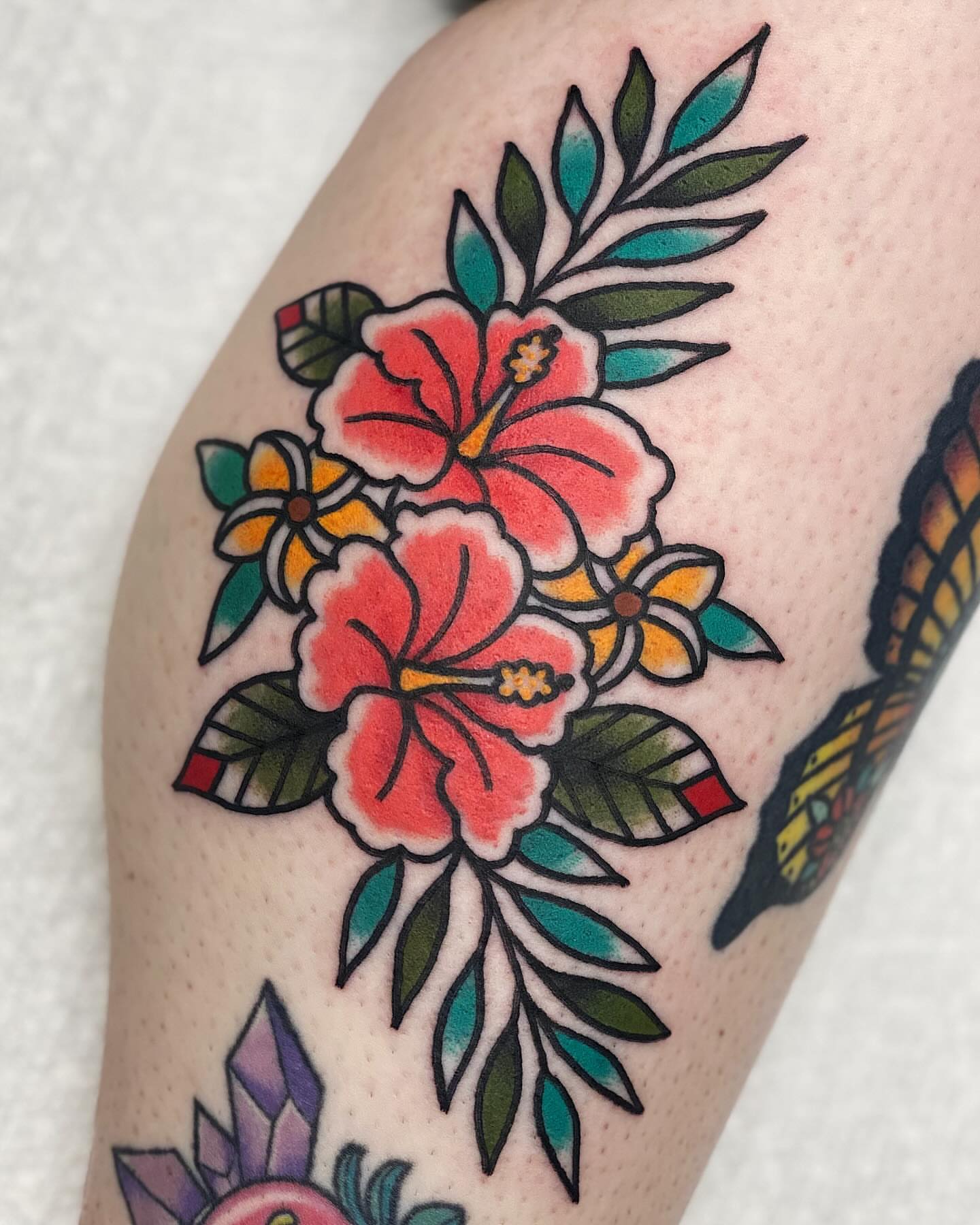 Hibiscus flowers American traditional tattoo on the forearm by Dakota Amato