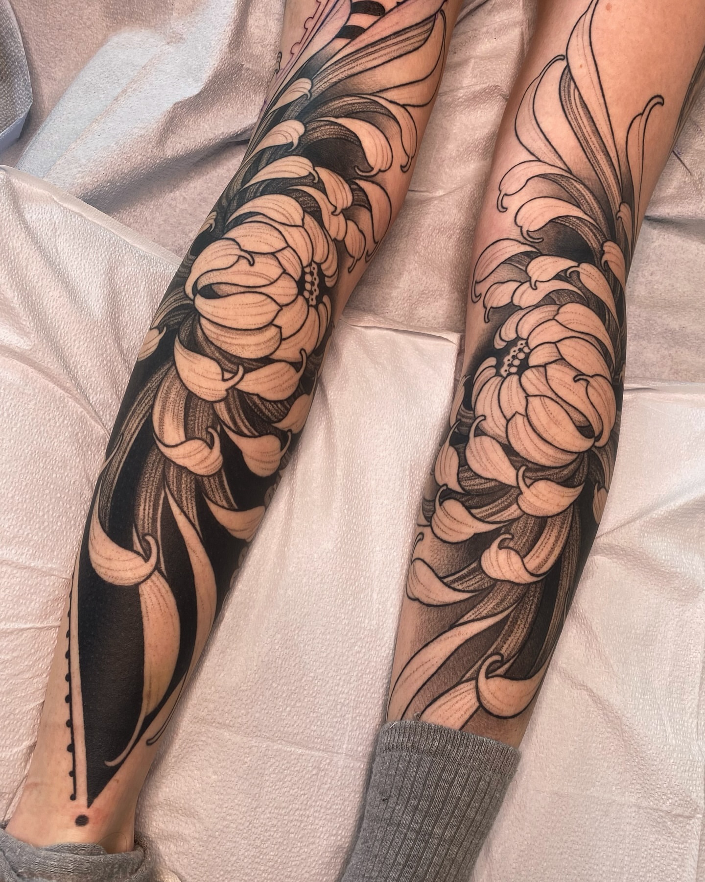 Chrysanthemum black and grey tattoo on the forearm by Natasha Dickinson
