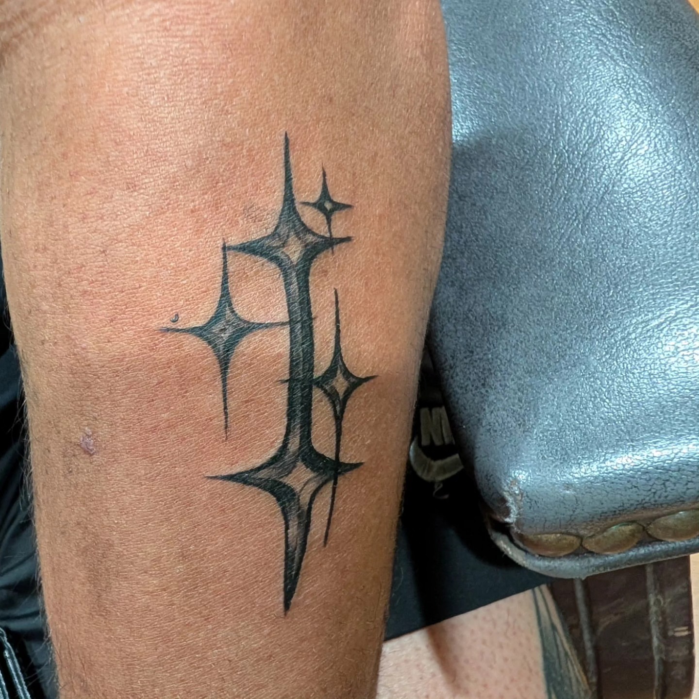 Cross with stars black and grey tattoo on the forearm by zion