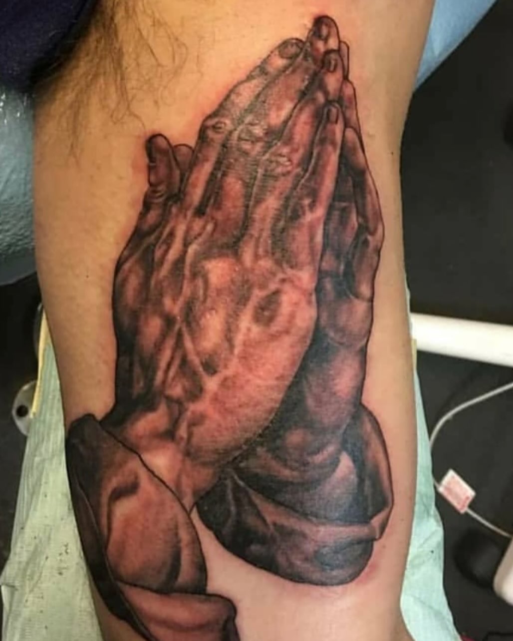 Praying hands realism tattoo on the forearm by Levi Cox, Powell, Ohio