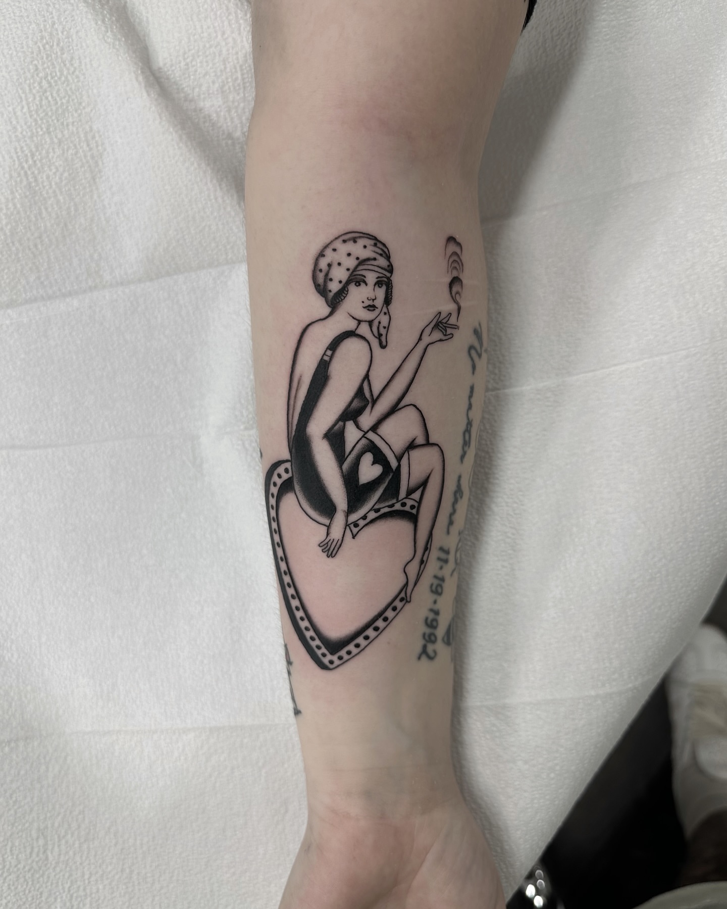 Woman on heart black and grey tattoo on the forearm by Nicholas Lee, San Francisco, California