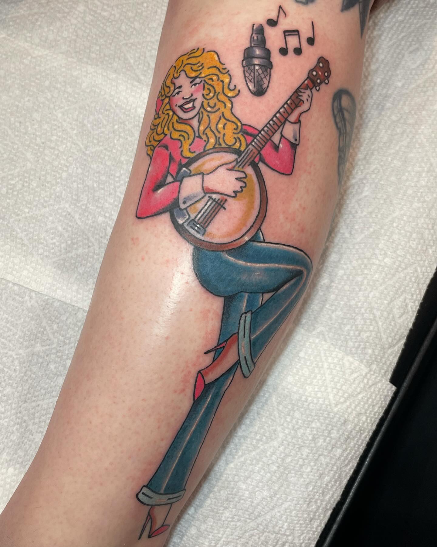 Banjo player American traditional tattoo on the forearm by Chrissy Ungrew Tattoos, Covington, Kentucky