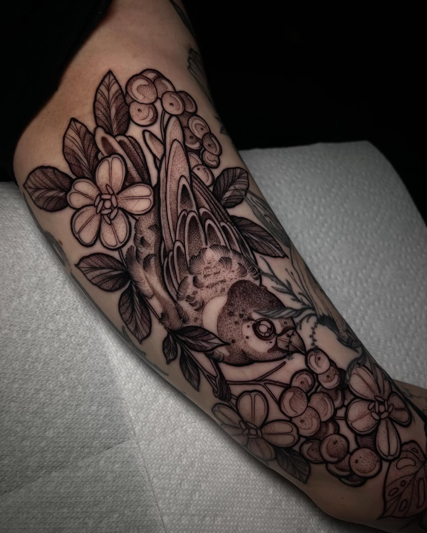 Bird and floral bouquet realism tattoo on the forearm by H A N N A H, Colorado Springs, Colorado