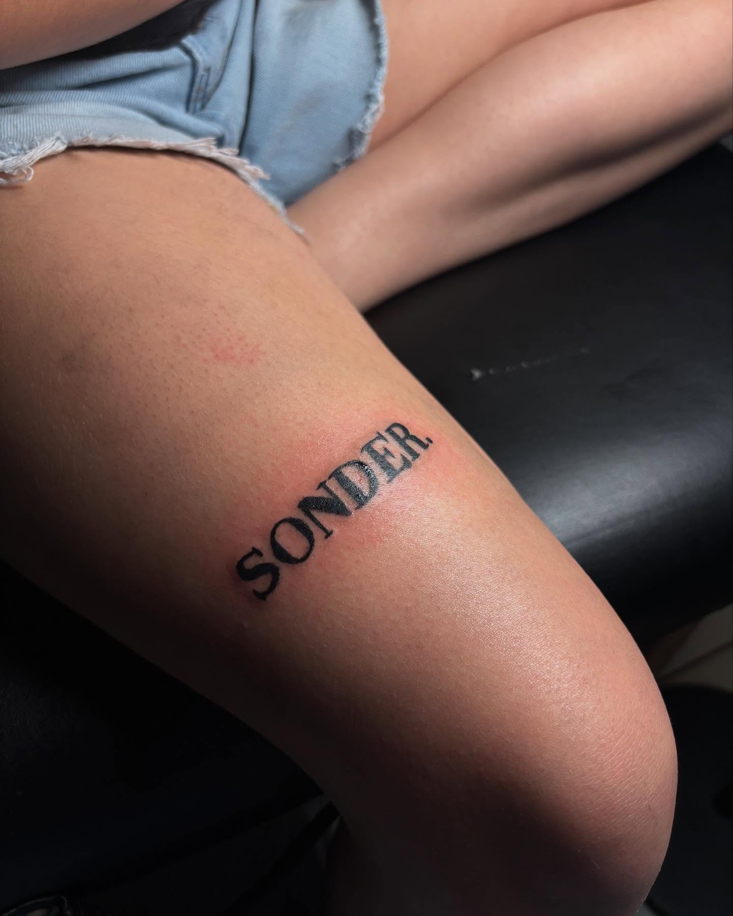 SONDER lettering script tattoo on the forearm by Mc X Happo