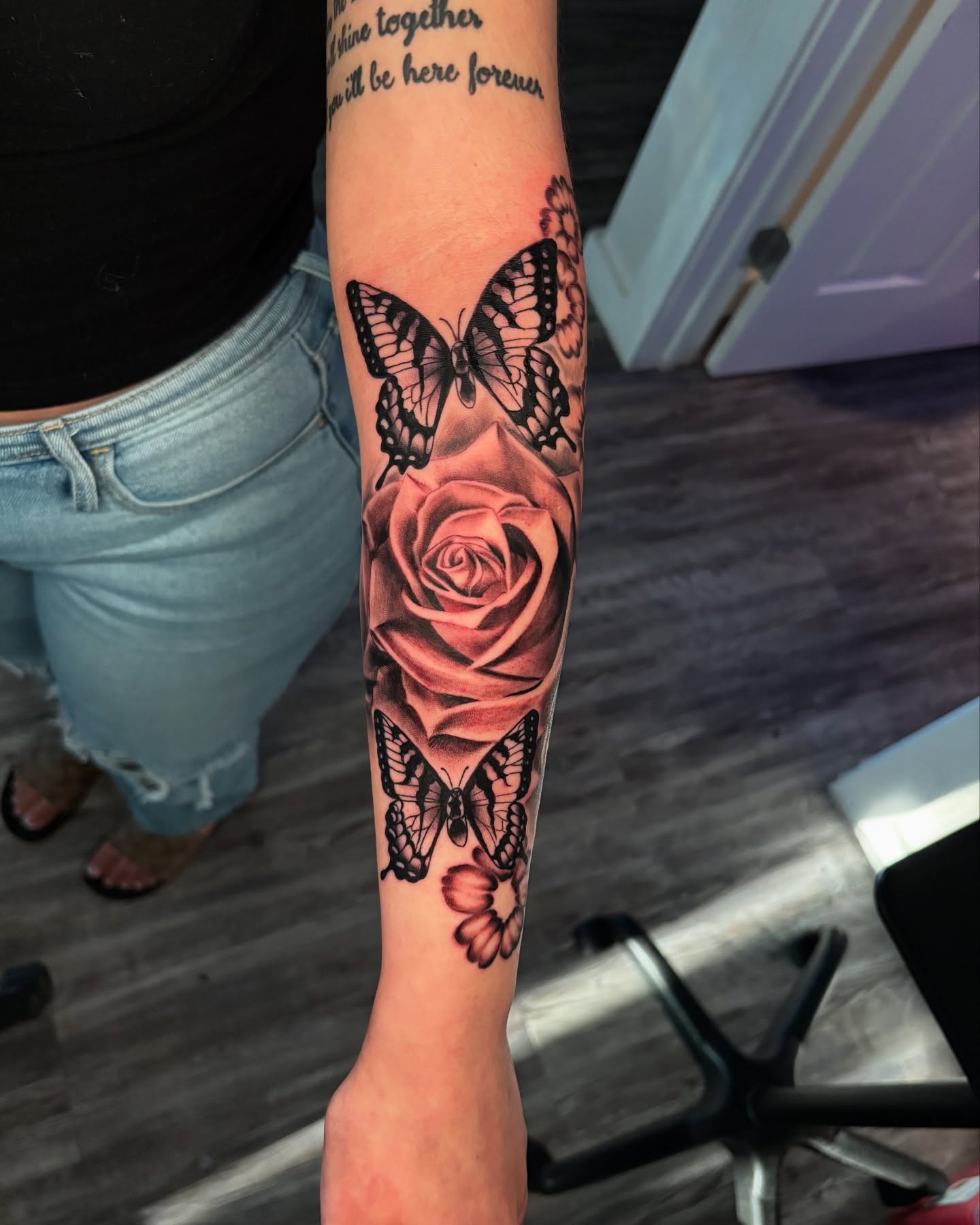Rose and butterflies realism tattoo on the forearm by Eric Garcia