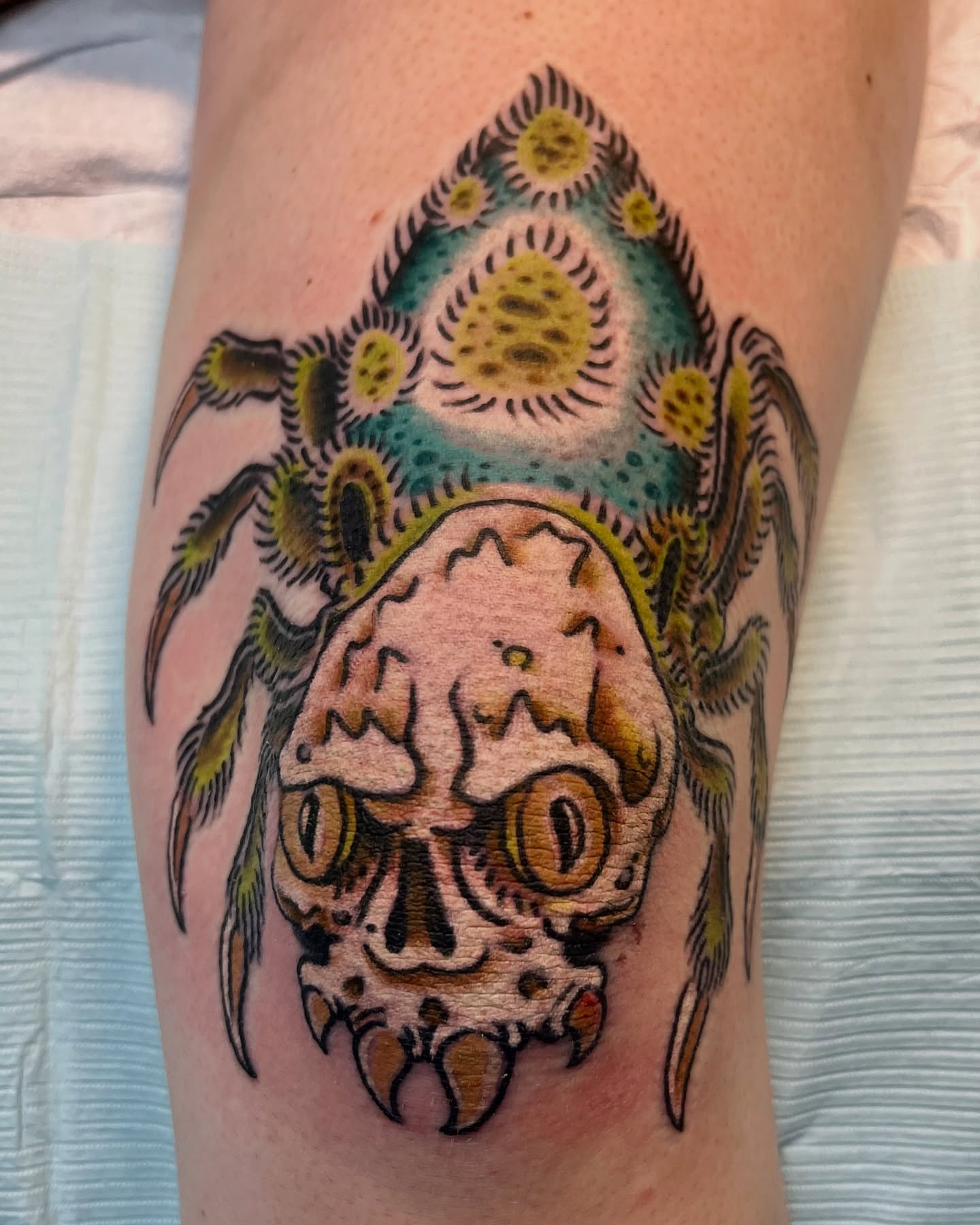 Skull with alien eyes American traditional tattoo on the forearm by Andrew Snowden