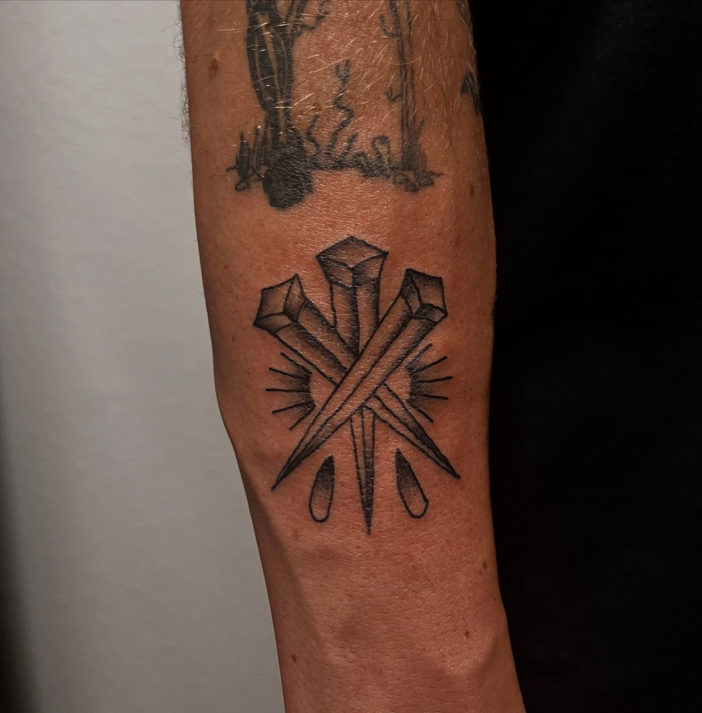 Cross with crystals geometric tattoo on the forearm by miranda