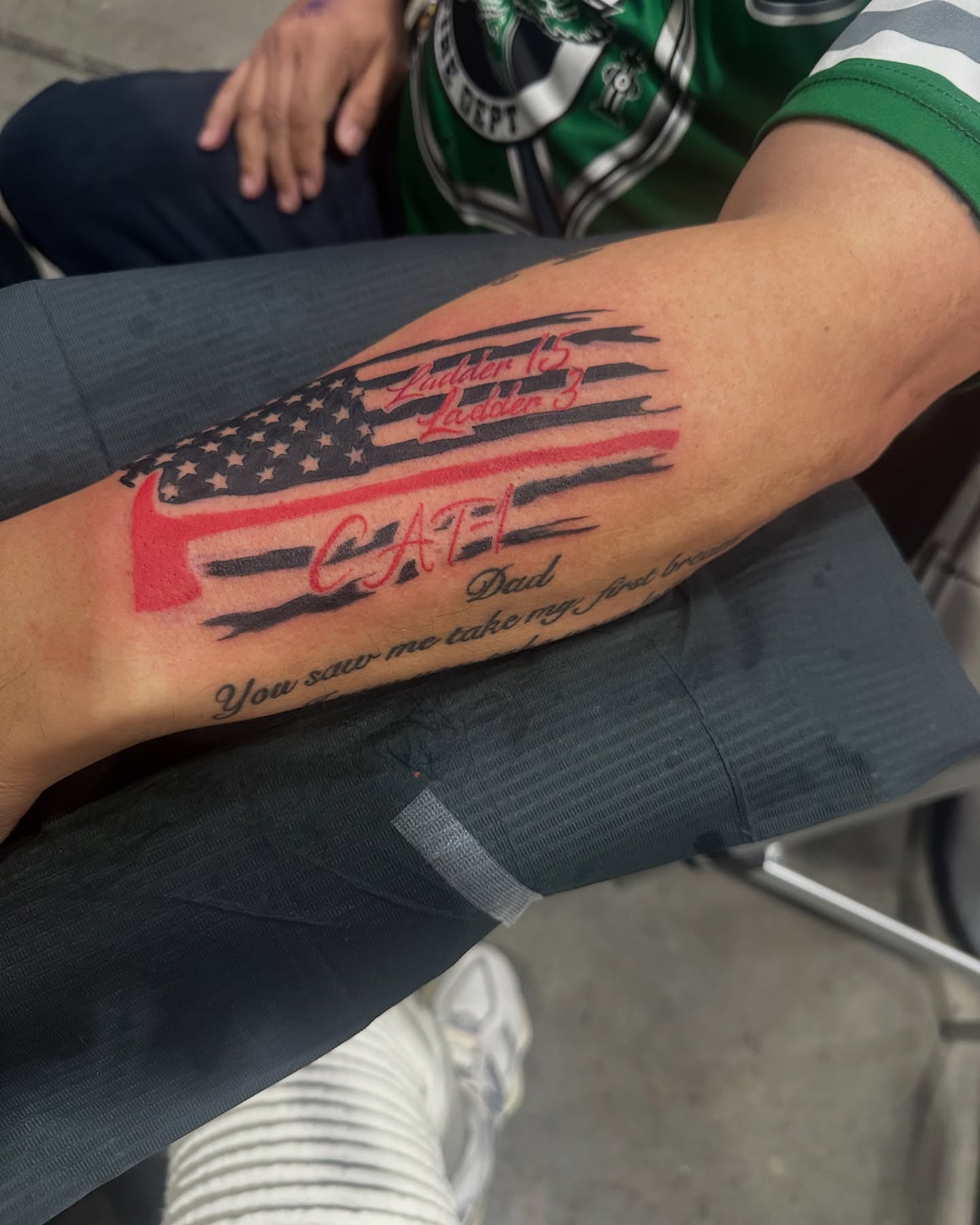 American flag with text American traditional tattoo on the forearm by Inked By E, Philadelphia, Pennsylvania