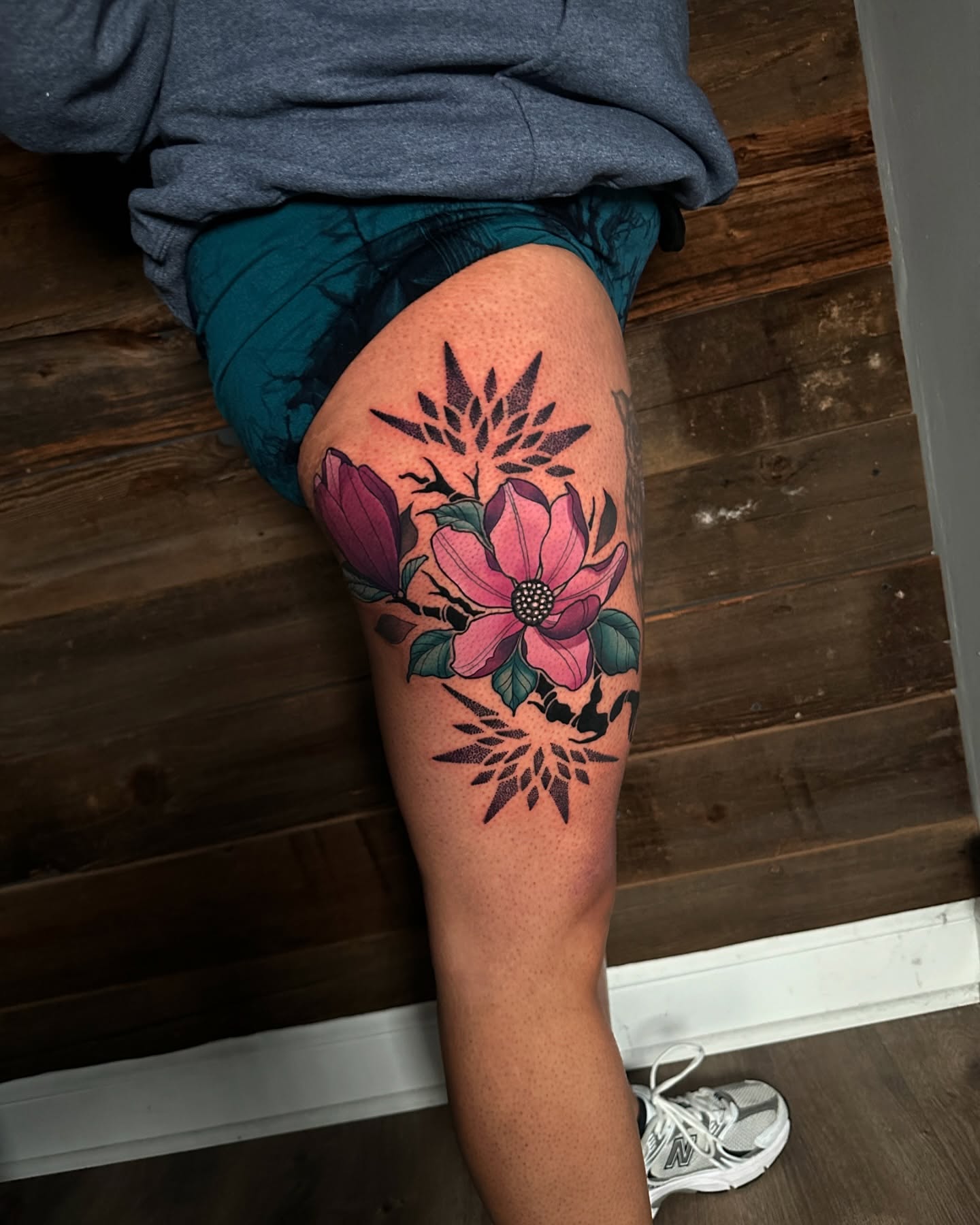 Magnolia flowers American traditional tattoo on the thigh by Joe Friedman