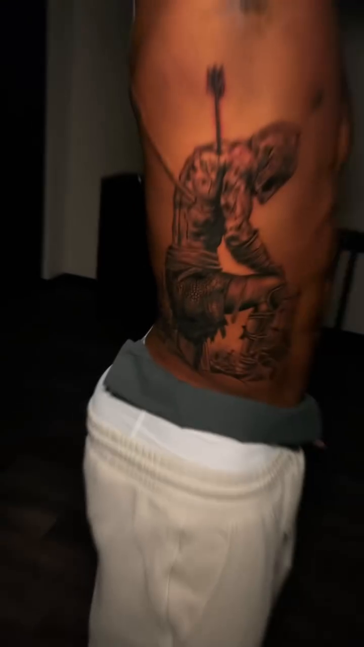 Kneeling warrior with arrow realism tattoo by Lucky Lefty