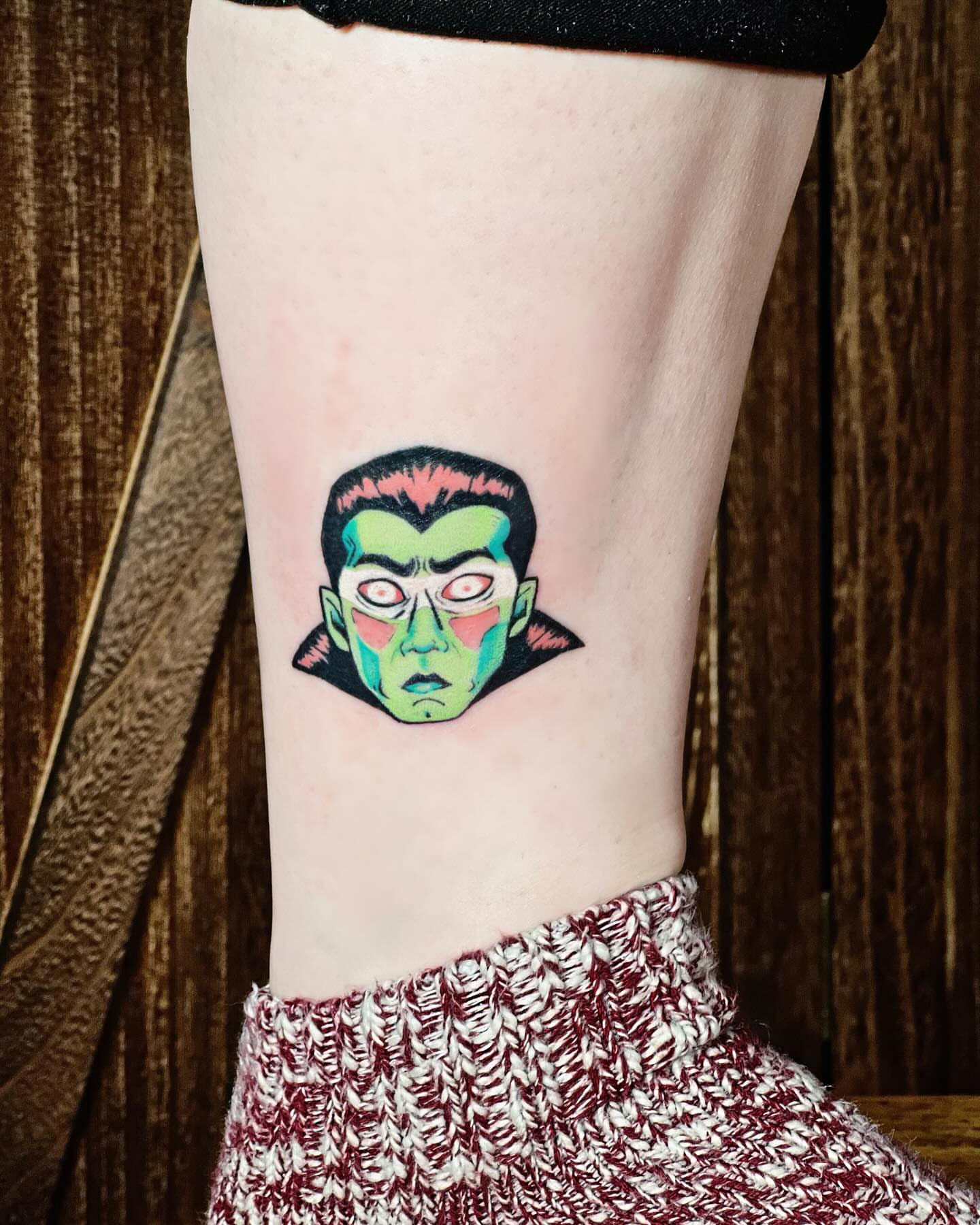 Vampire face geometric tattoo on the calf by Lex