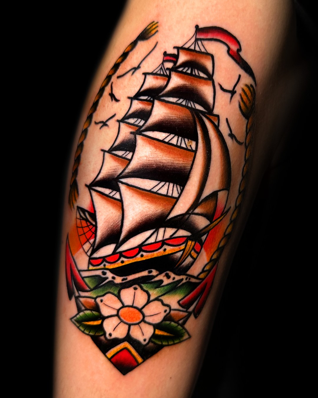 Ship and flower American traditional tattoo on the forearm by Massimiliano pennella