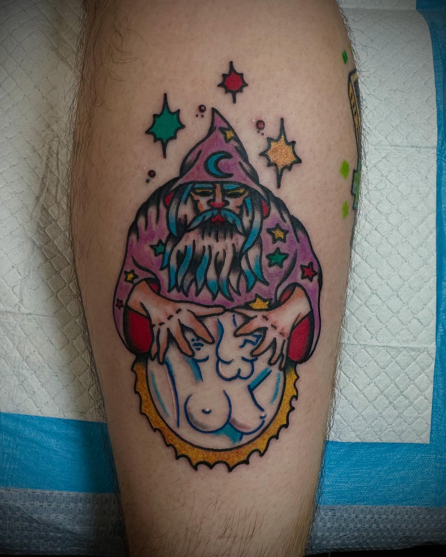Wizard and nude figure new school tattoo on the thigh by Olive Kelley