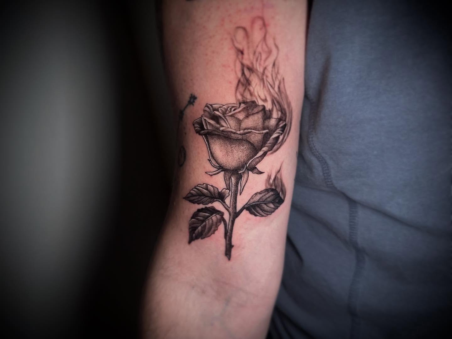 Burning rose realism tattoo on the forearm by Terence Taylor