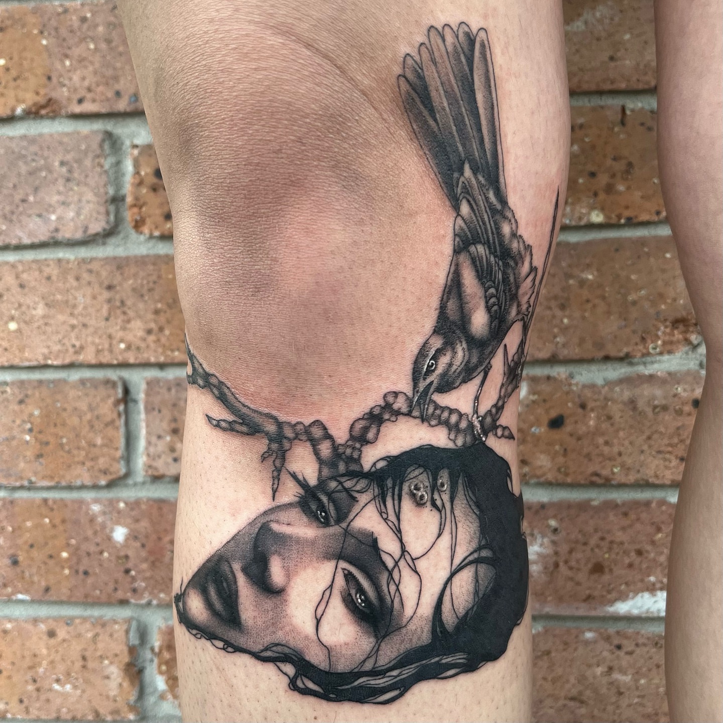 Woman's face with crow realism tattoo on the forearm by Myla Jane, Houston, Texas