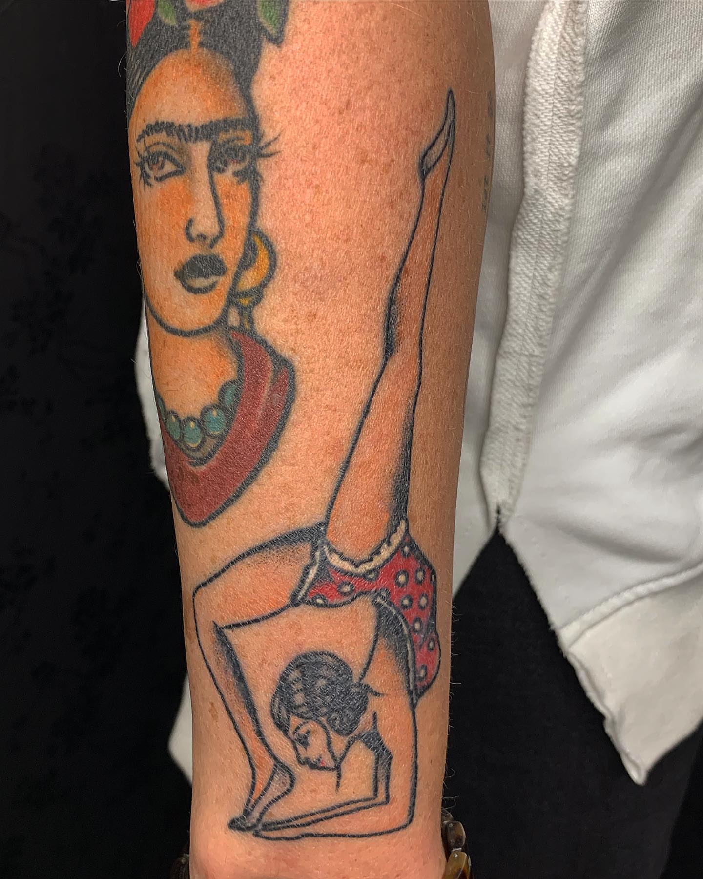 Pin-up girl American traditional tattoo on the forearm by Brii Moser