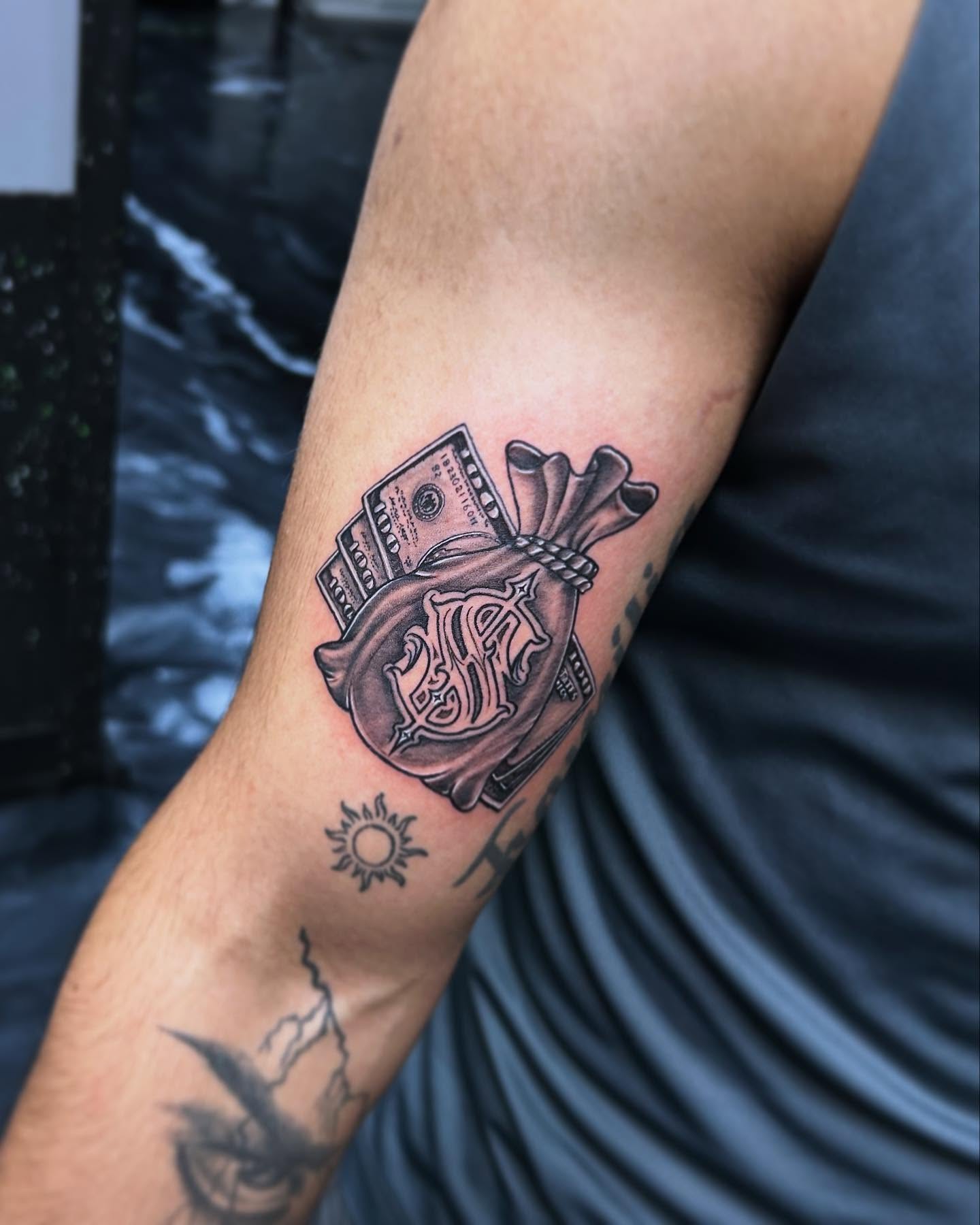 Money bag black and grey tattoo on the forearm by 302inkgod, Wilmington, Delaware