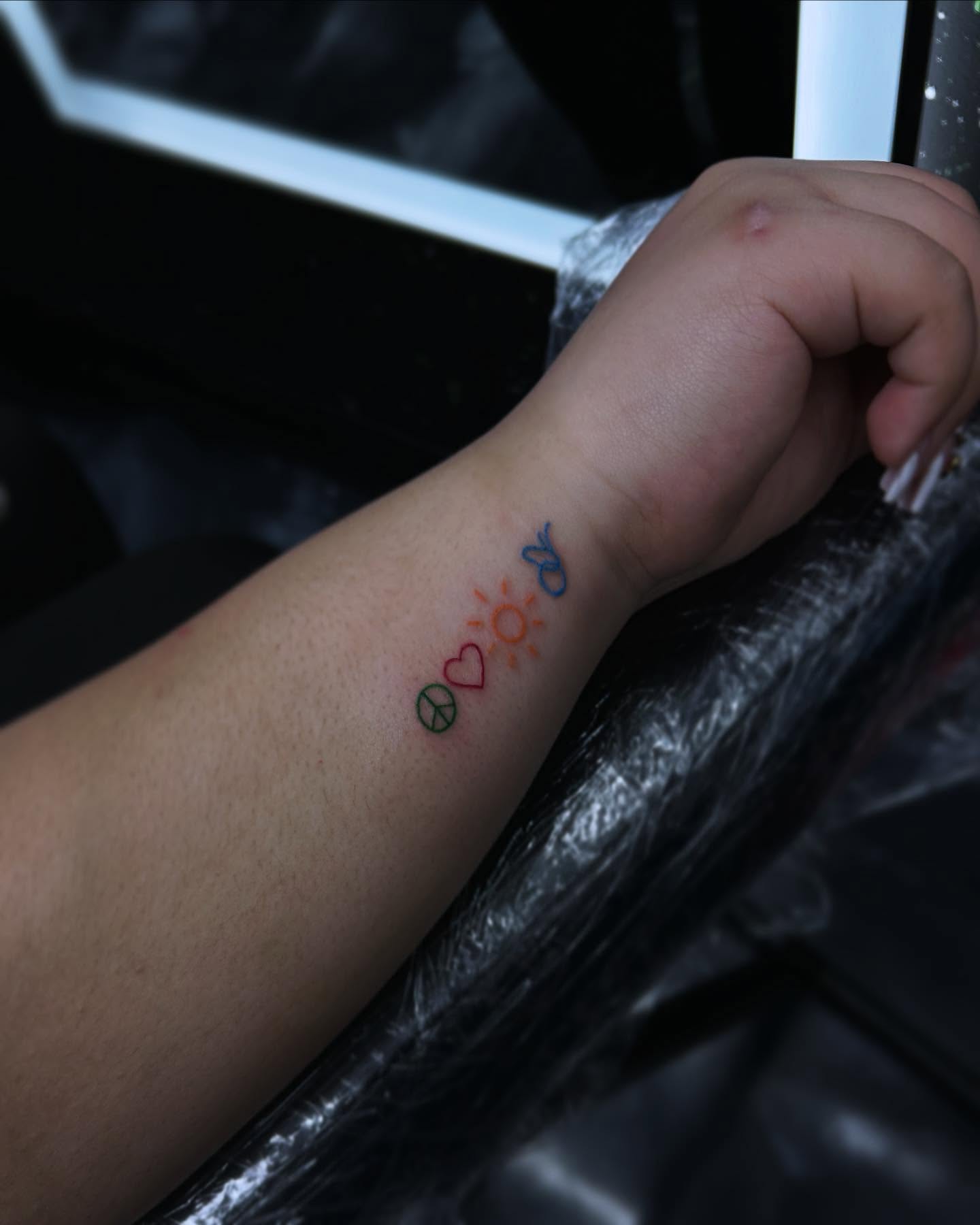 Peace sign, heart, sun, butterfly geometric tattoo on the forearm by 302inkgod, Wilmington, Delaware