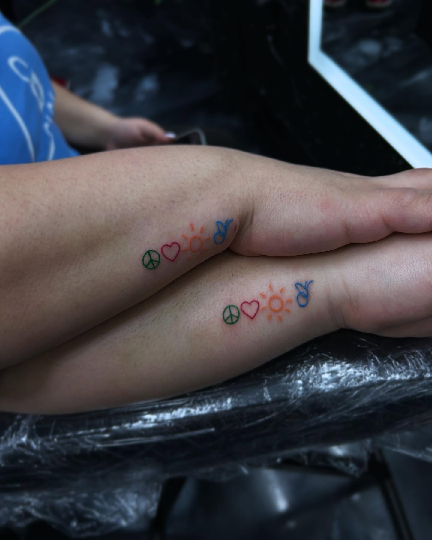 Peace, heart, sun, butterfly trash polka tattoo on the forearm by 302inkgod, Wilmington, Delaware