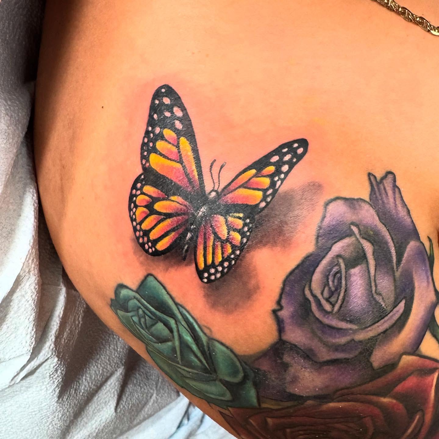 Butterfly and rose realism tattoo on the thigh by Yayo, New Britain, Connecticut