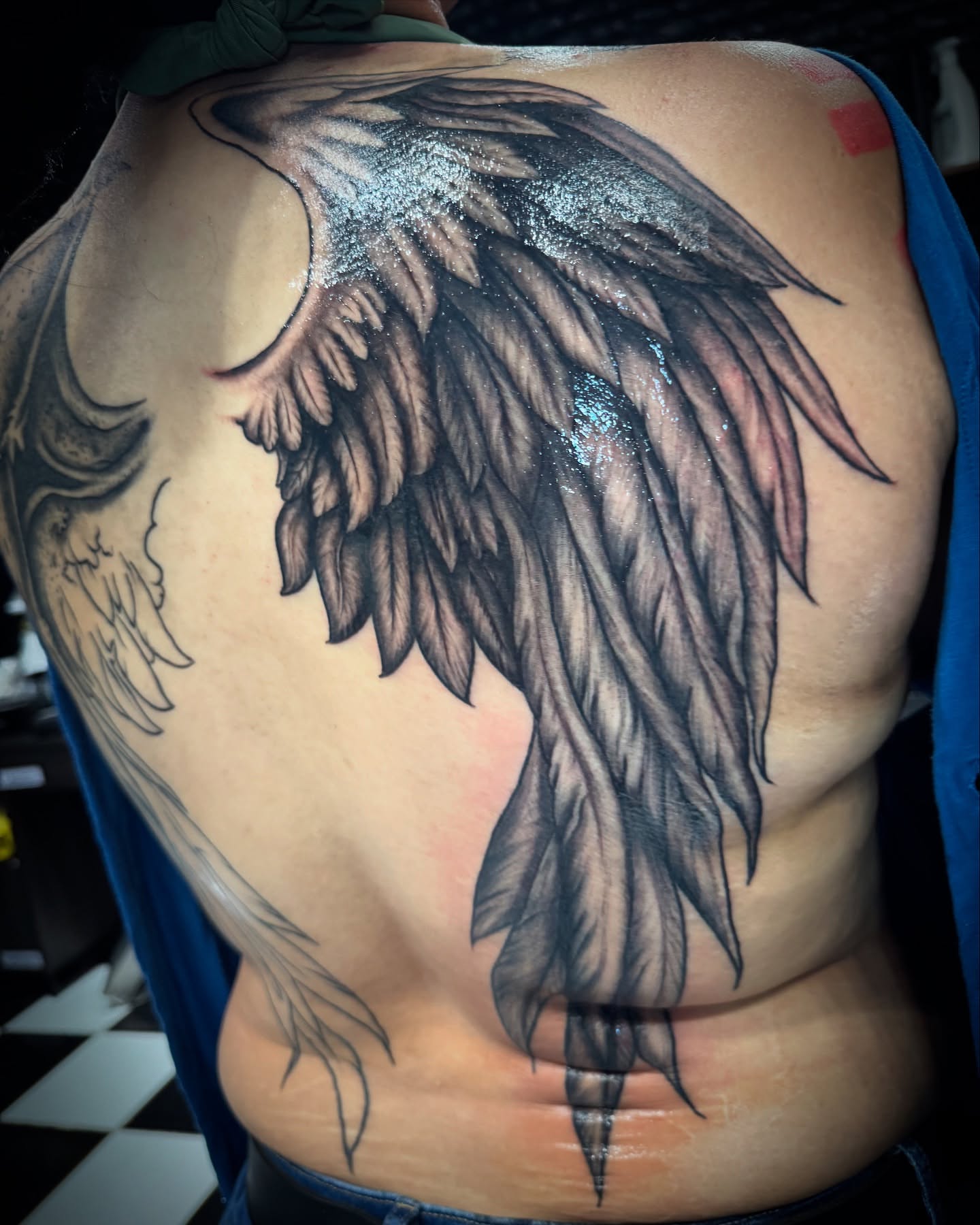 Wings black and grey tattoo on the back by Christa Martinez