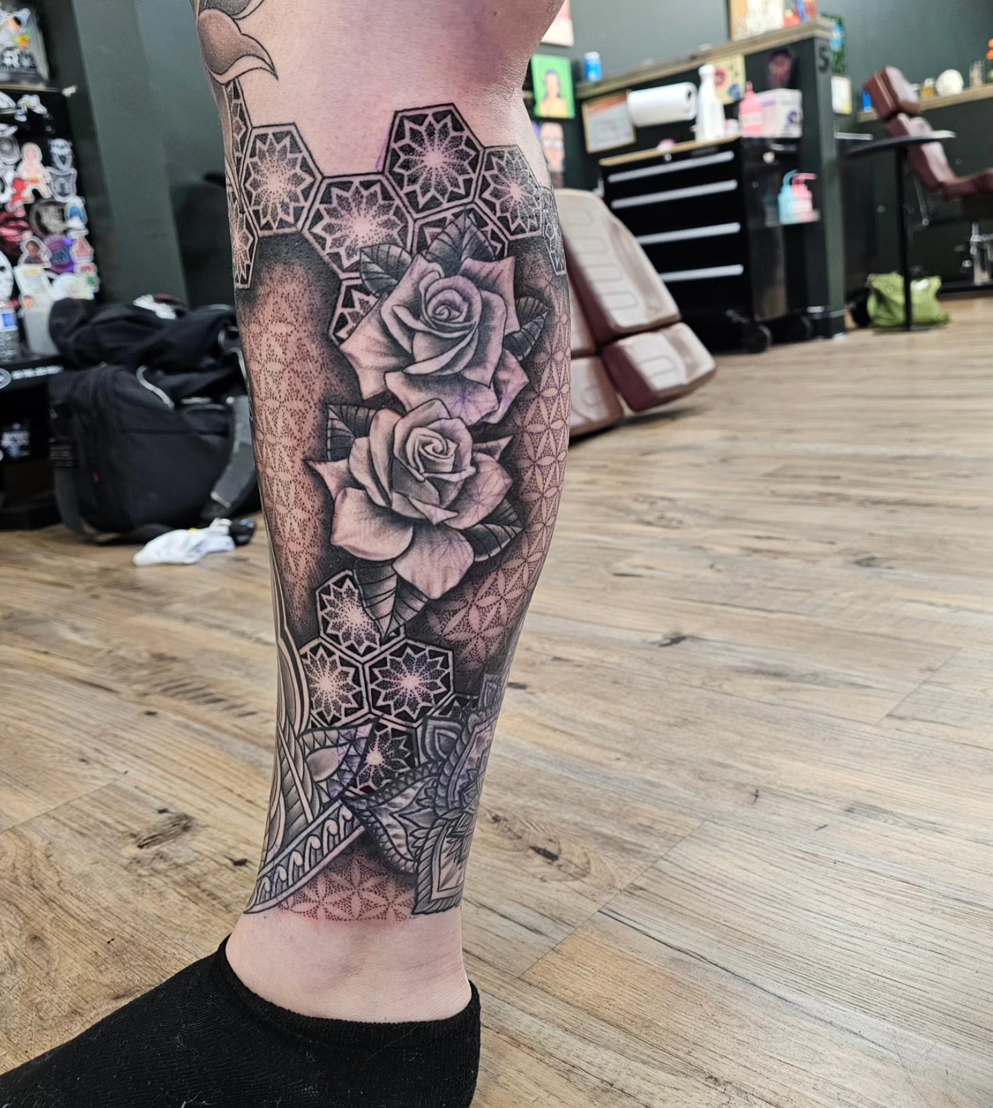 Roses and geometric patterns geometric tattoo on the calf by Derek Davis