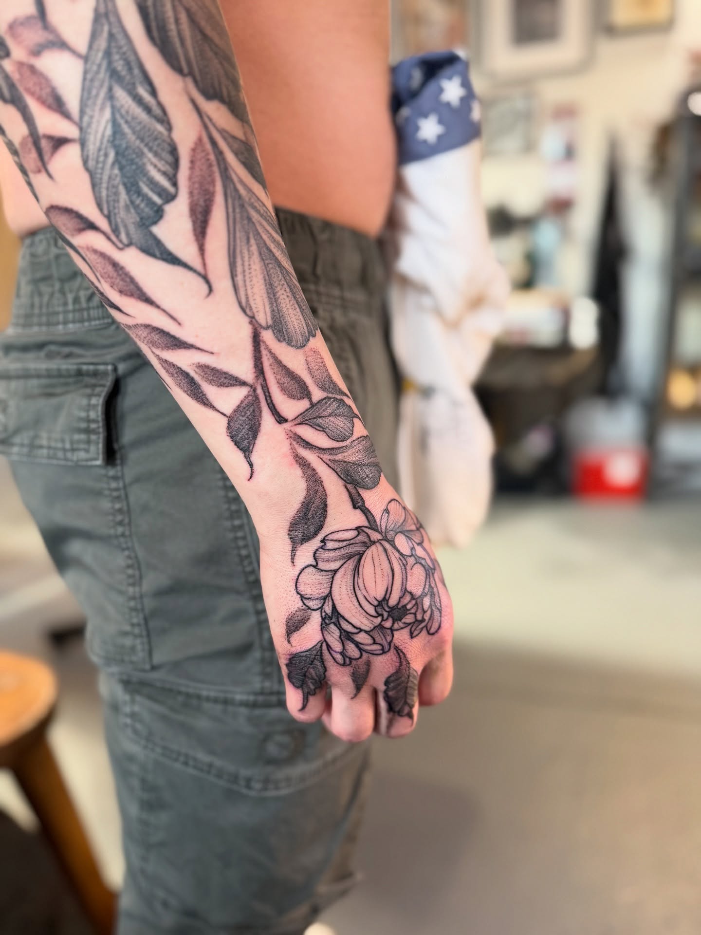 Floral arrangement black and grey tattoo on the forearm by Benjamin Carlson