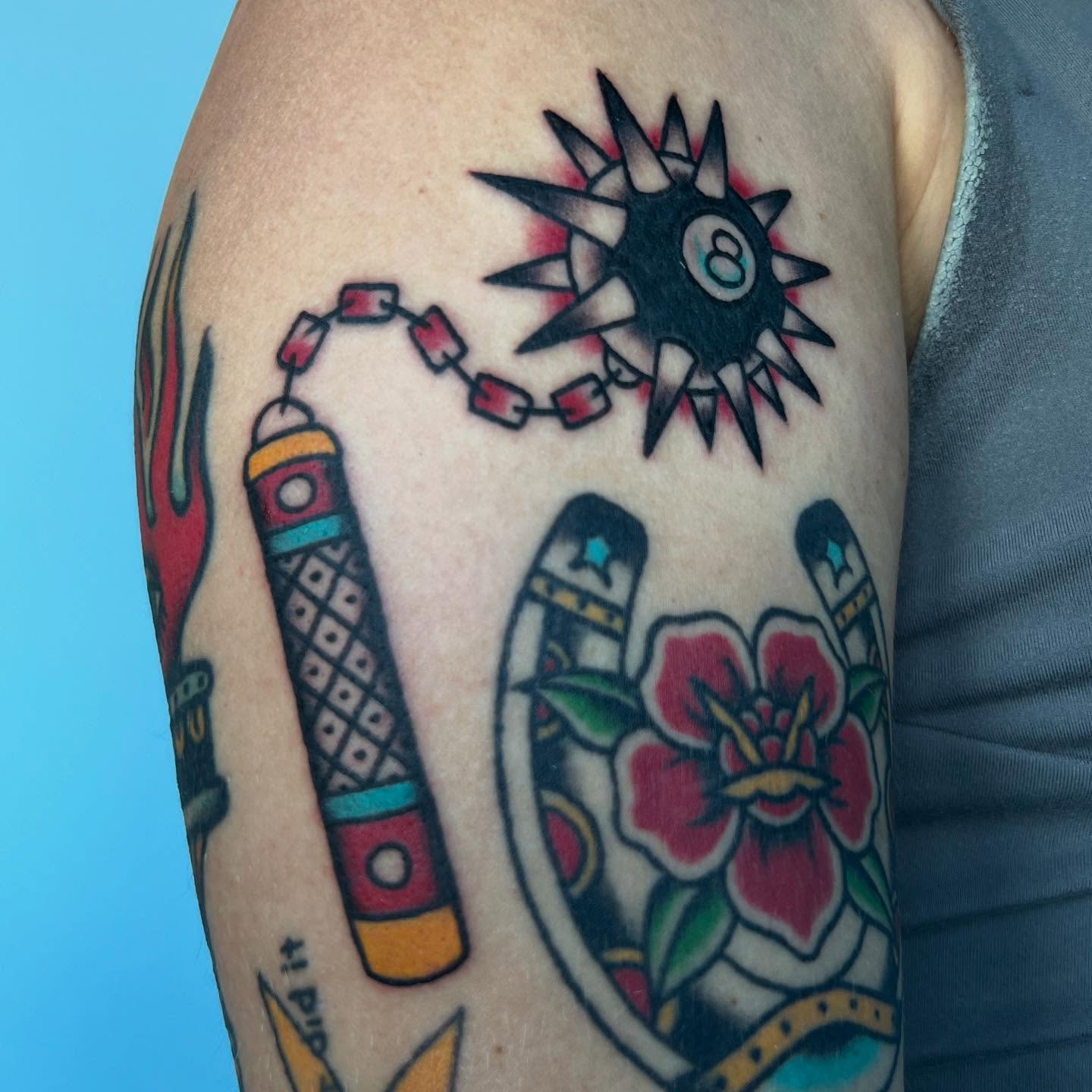 Firecracker and flower American traditional tattoo on the upper arm by ✮KAT✮