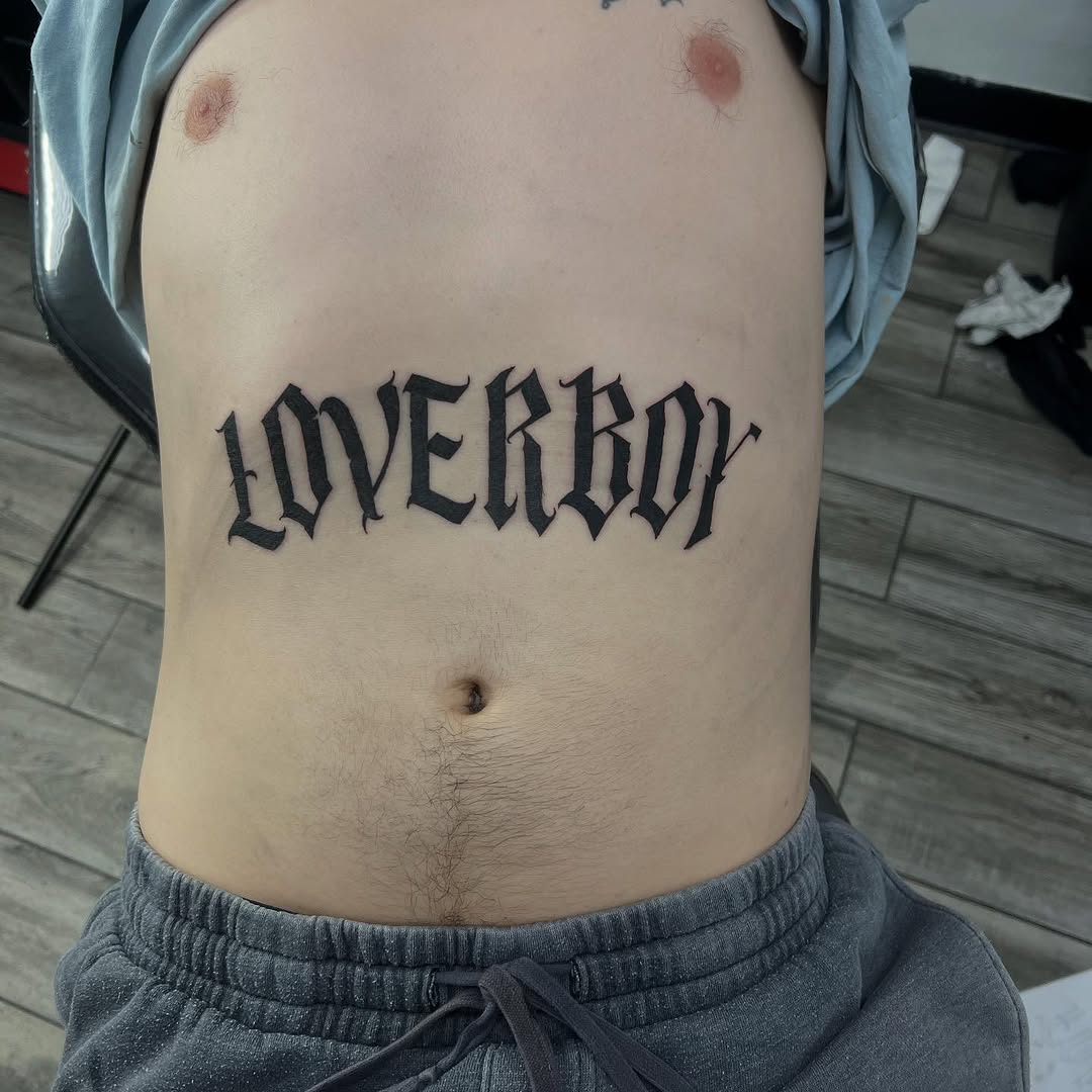 Loverboy text Chicano tattoo on the ribs by Renzoe_piercingz