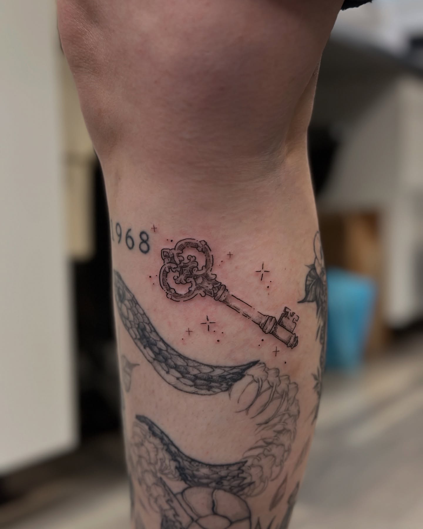 Key and snake black and grey tattoo on the forearm by Sabrina, Harrison, New Jersey