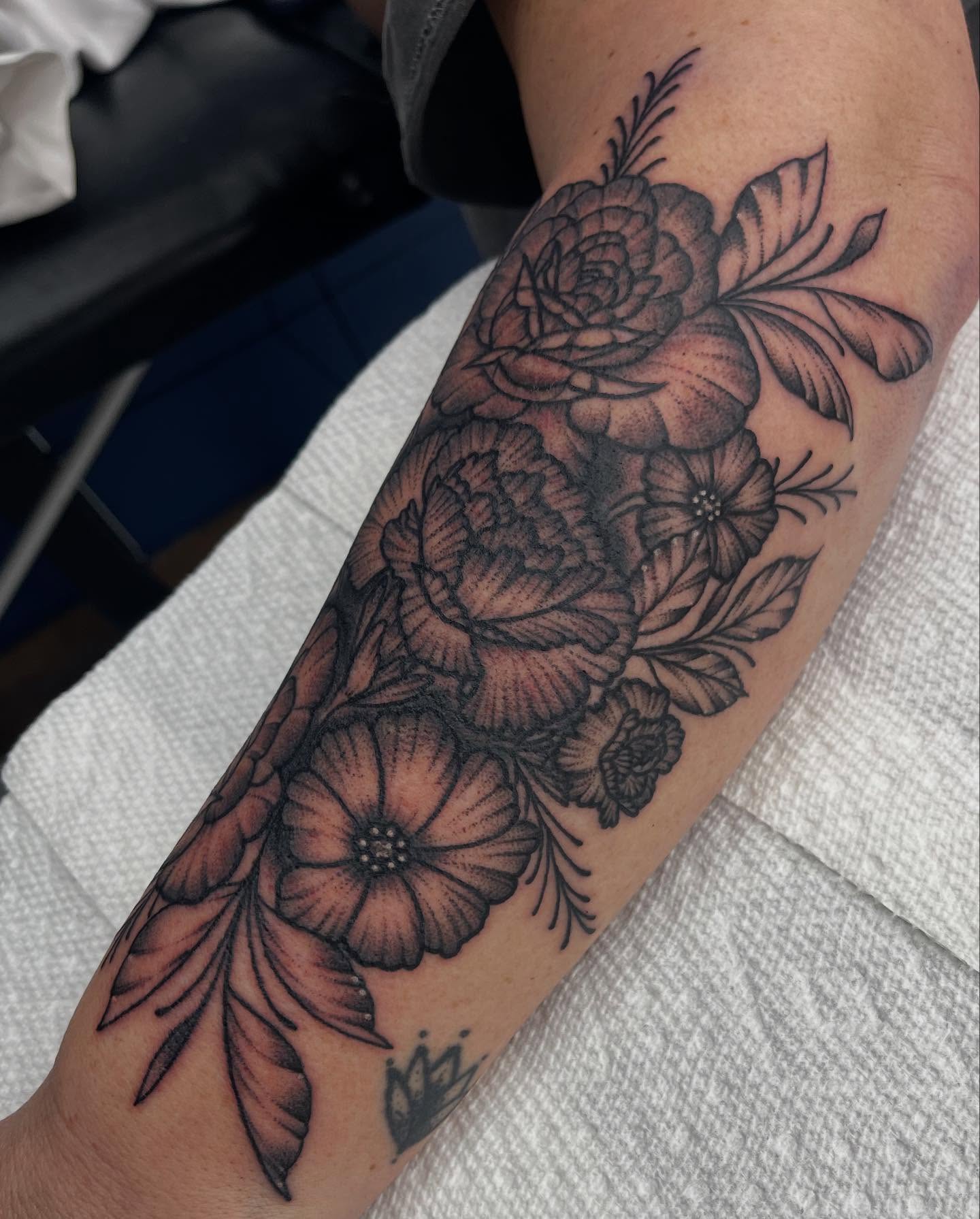Floral bouquet black and grey tattoo on the forearm by Autumn Fulford