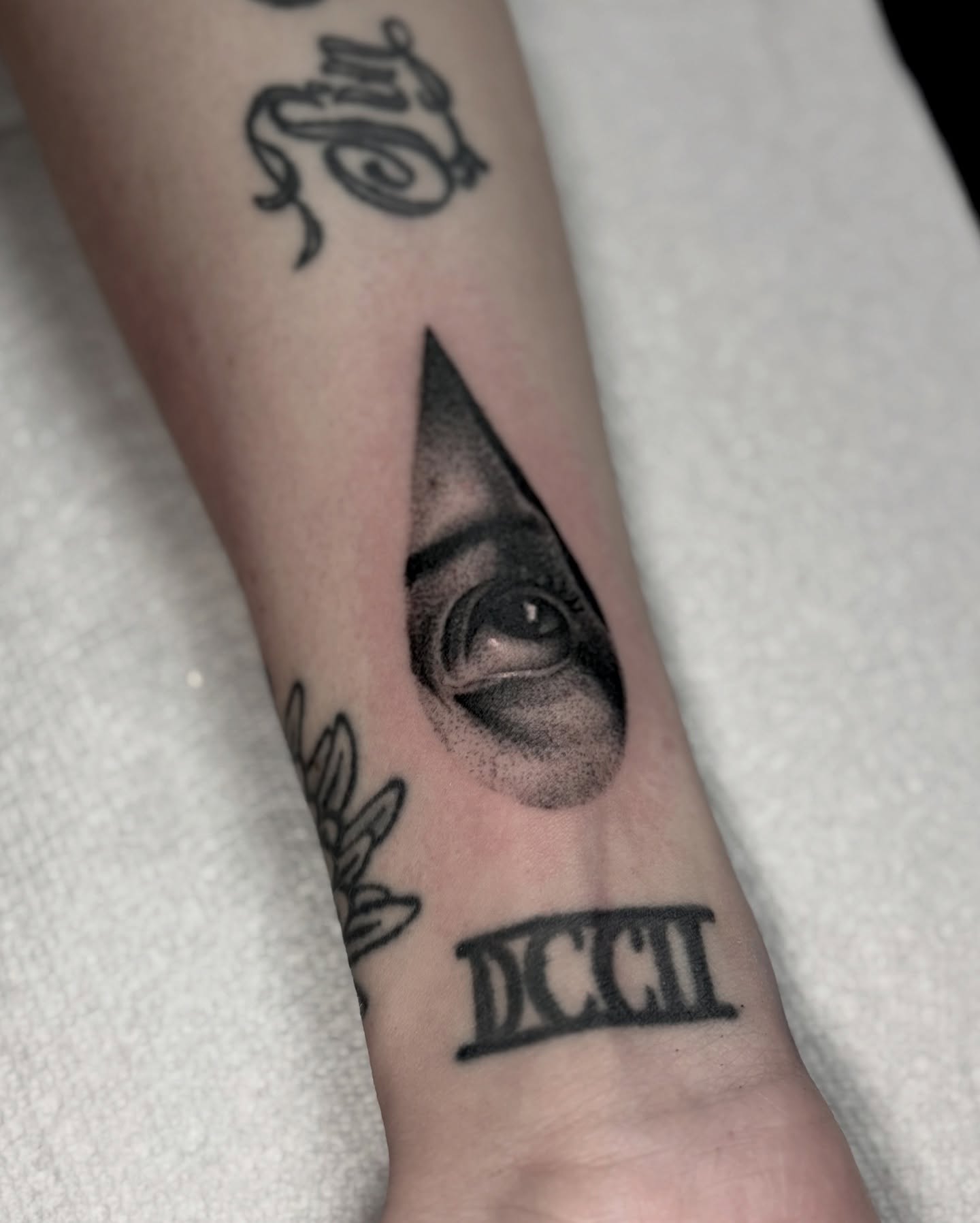 Eye within pyramid dotwork tattoo on the forearm by Bryan
