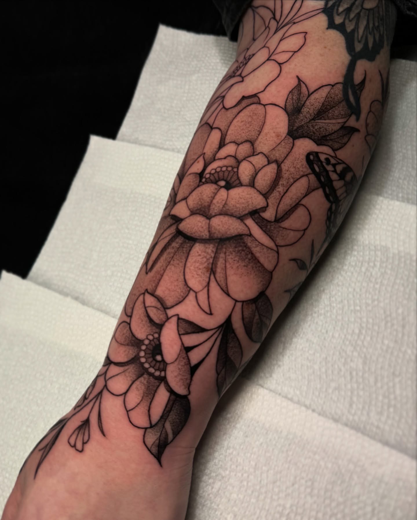 Floral bouquet dotwork tattoo on the forearm by Lauren Peltz