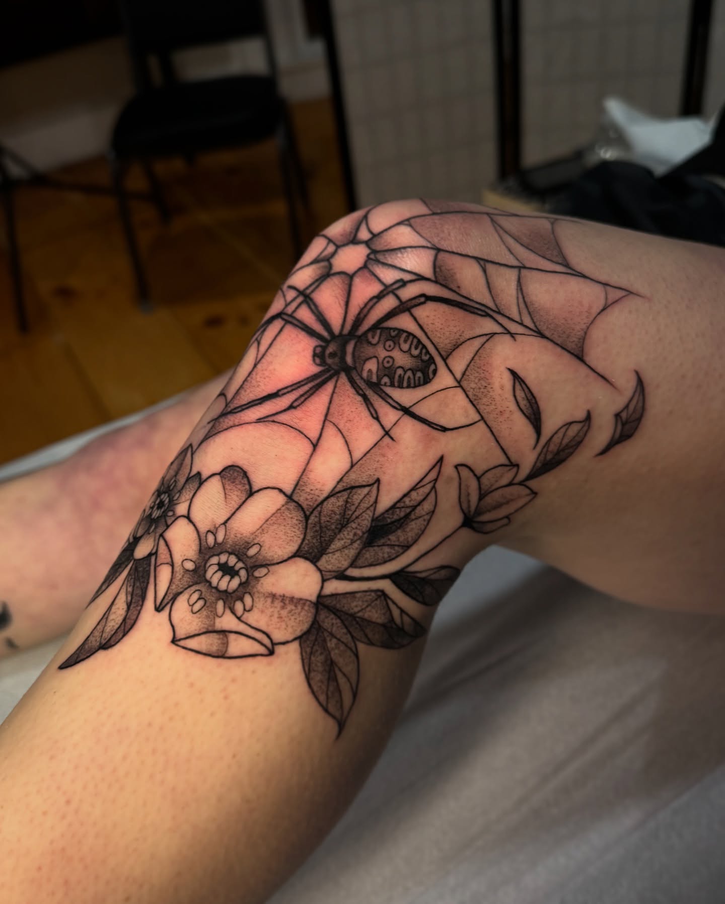 Spider and flowers realism tattoo on the forearm by Lauren Peltz