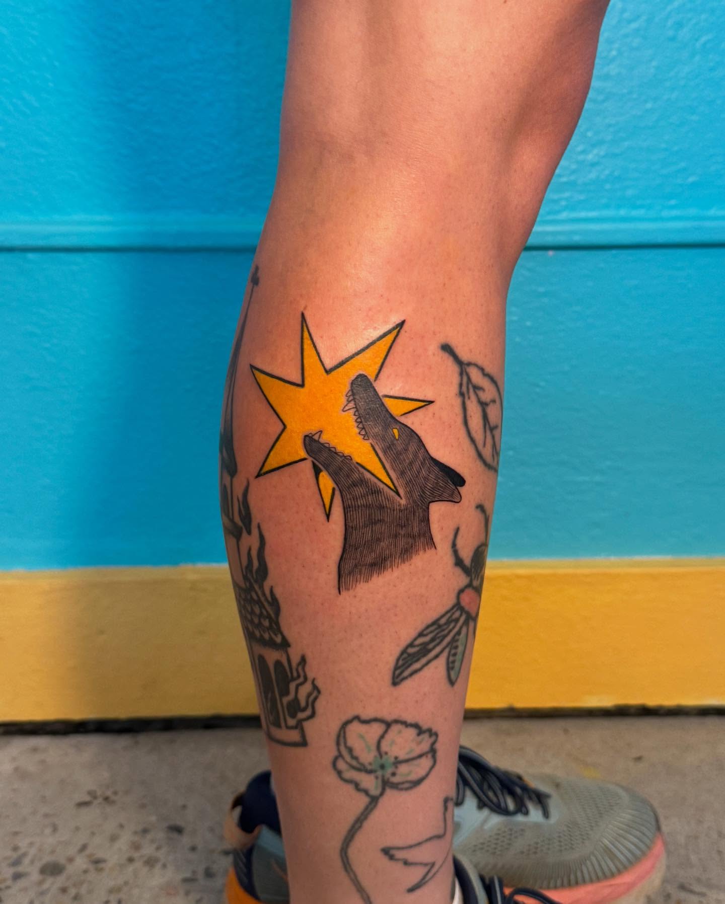 Wolf howling at star American traditional tattoo on the forearm by Ivy