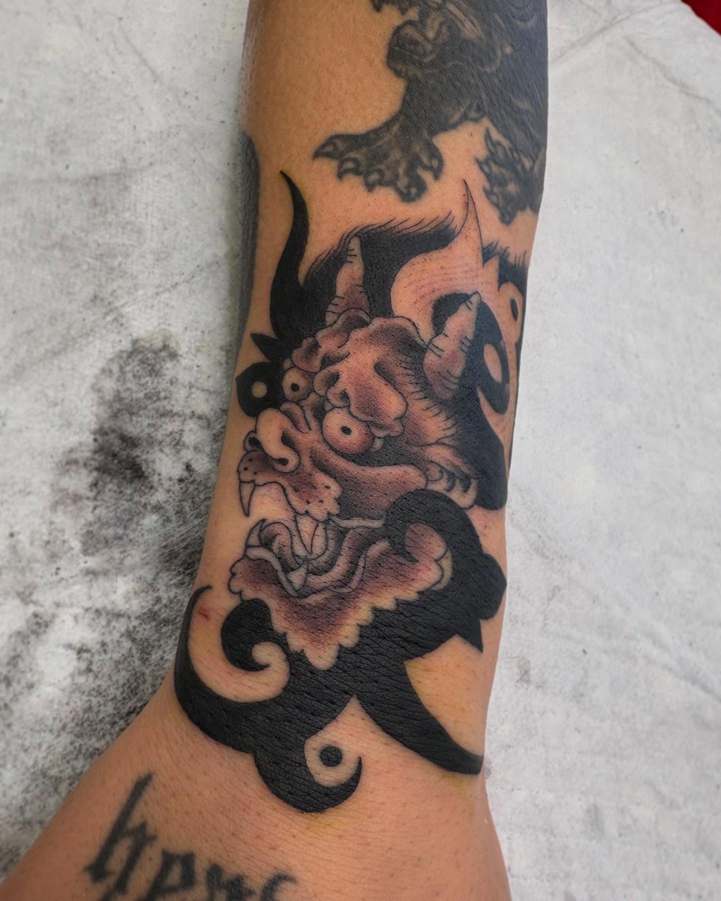 Lion American traditional tattoo on the forearm by Zach Hendrickson
