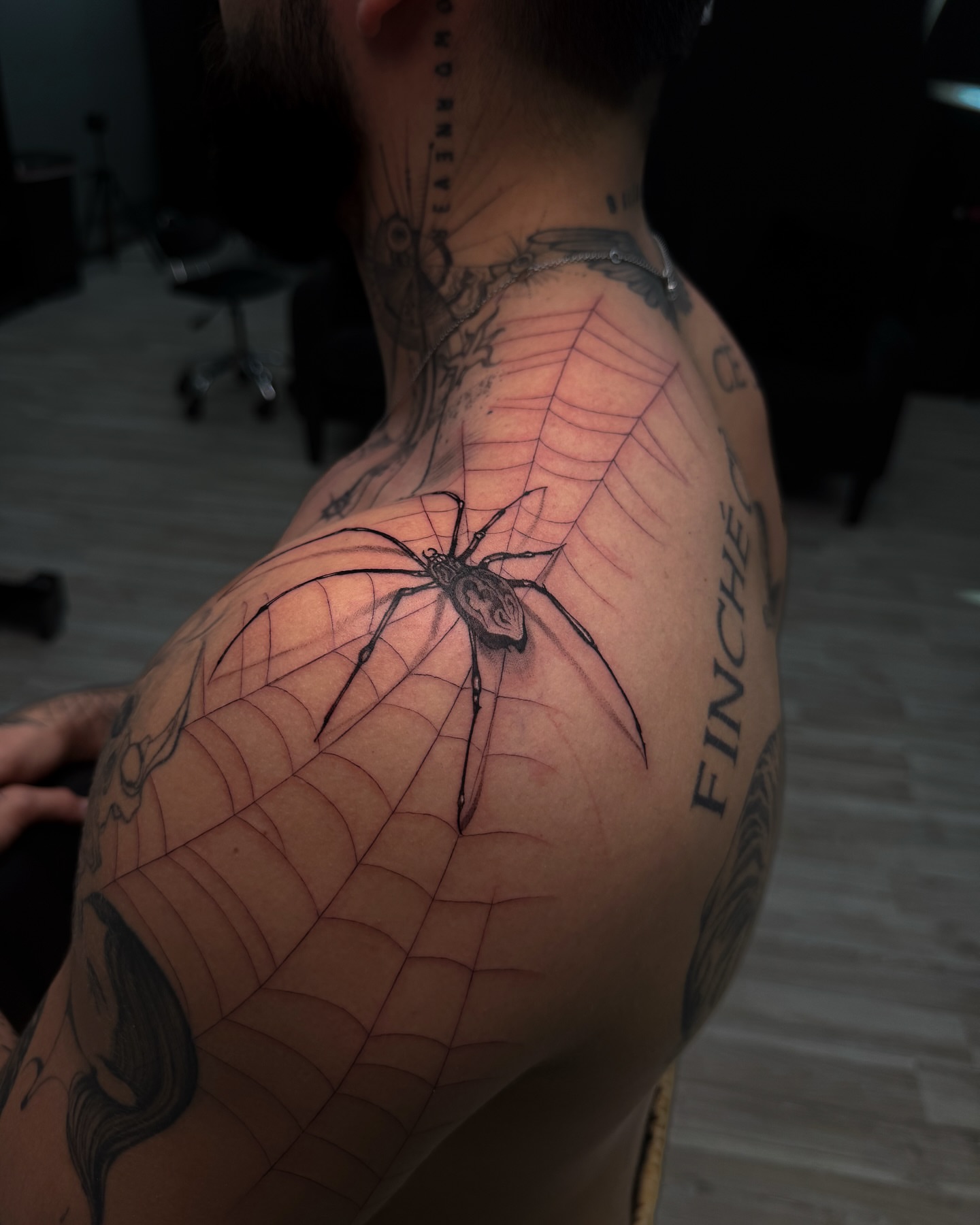 Spider web realism tattoo on the shoulder by Nicolas Herrera