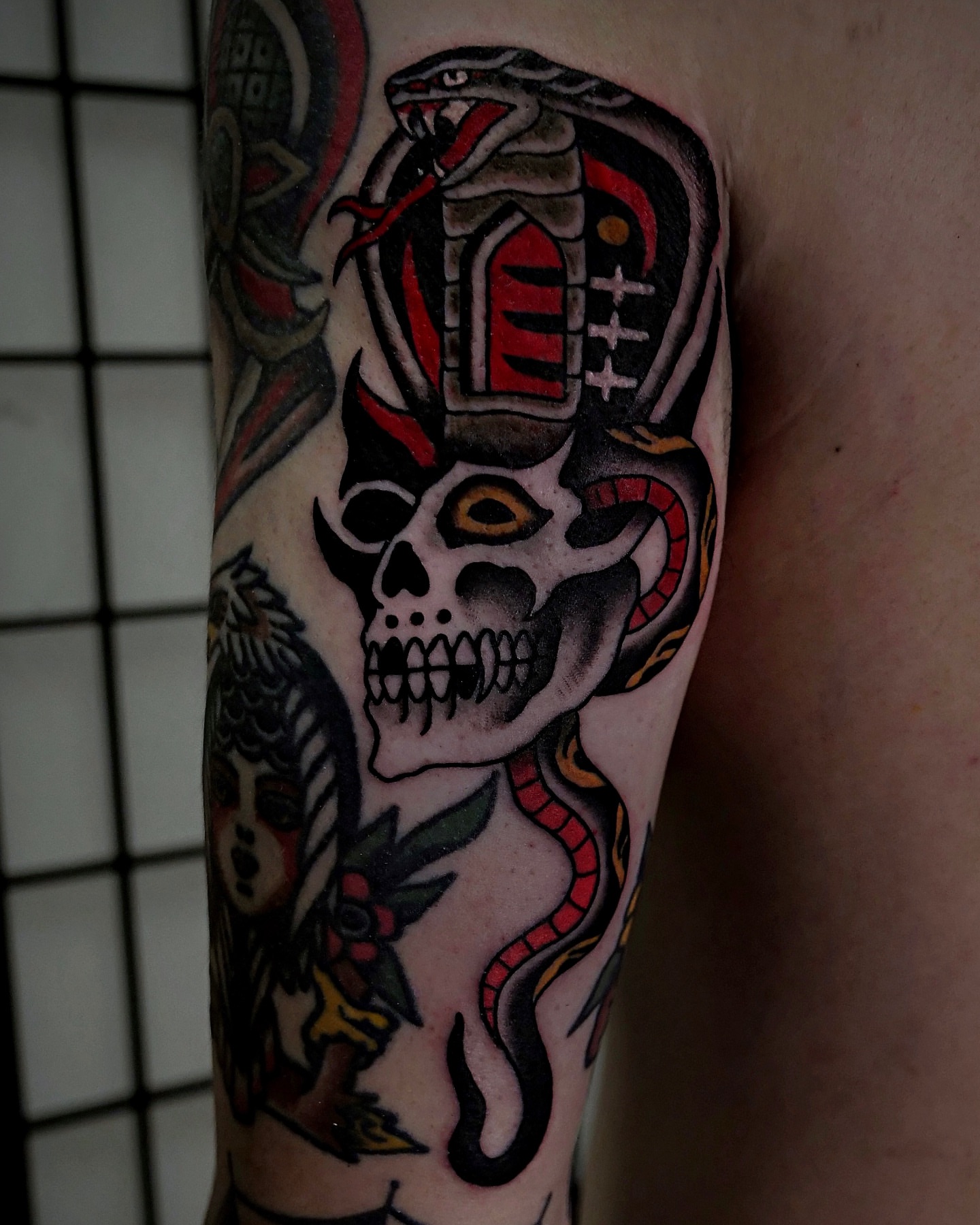 Skull and snake American traditional tattoo on the forearm by Brandon Murphy