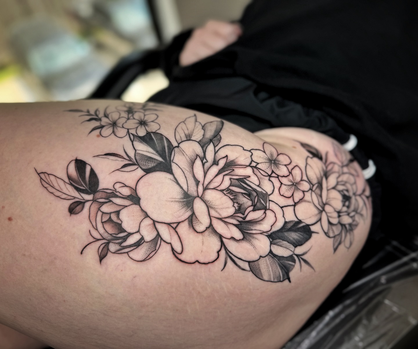 Floral bouquet black and grey tattoo on the thigh by David Gray