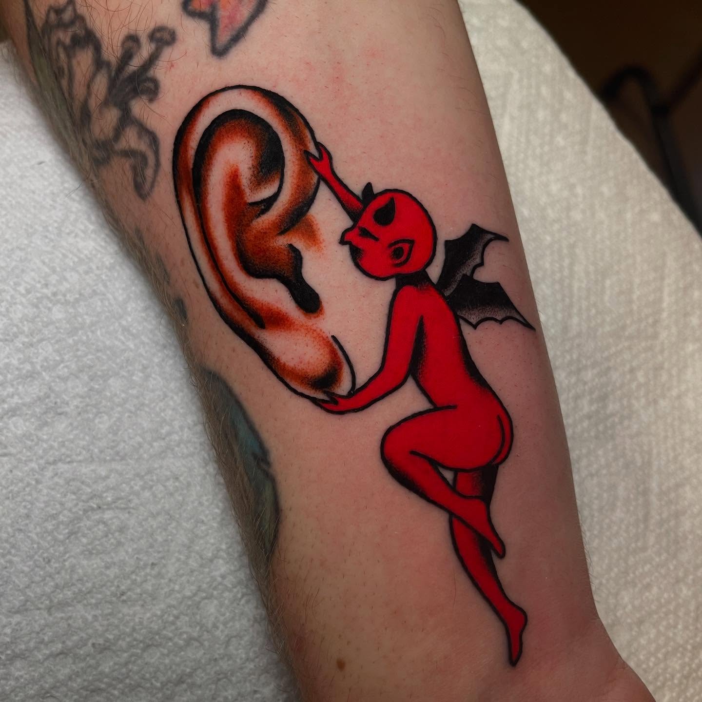 Red devil new school tattoo on the forearm by Marqui Watling